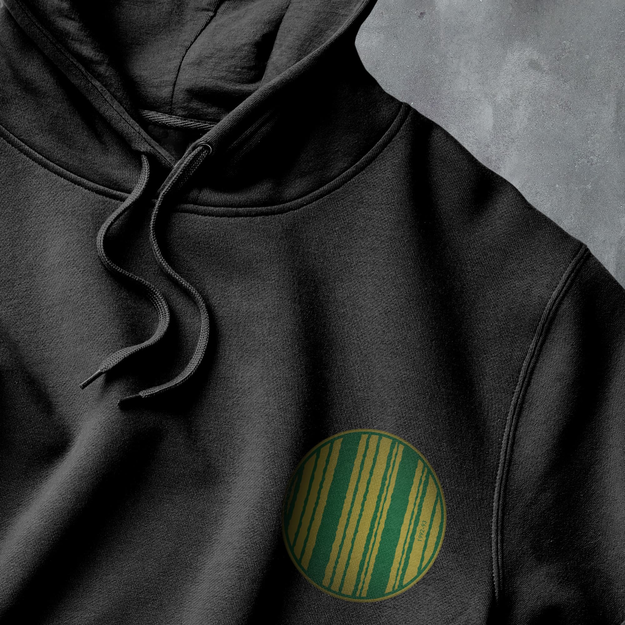 a black hoodie with a green circle on it