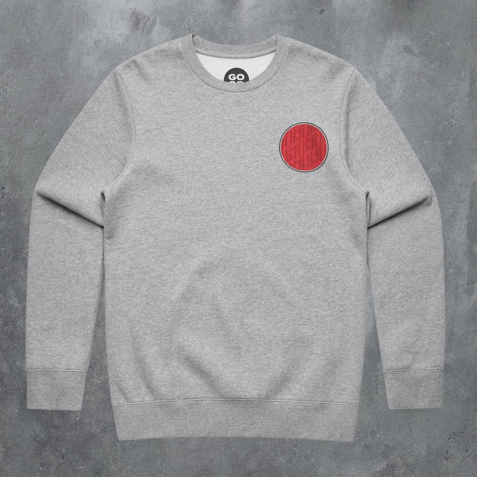 a grey sweatshirt with a red circle on it