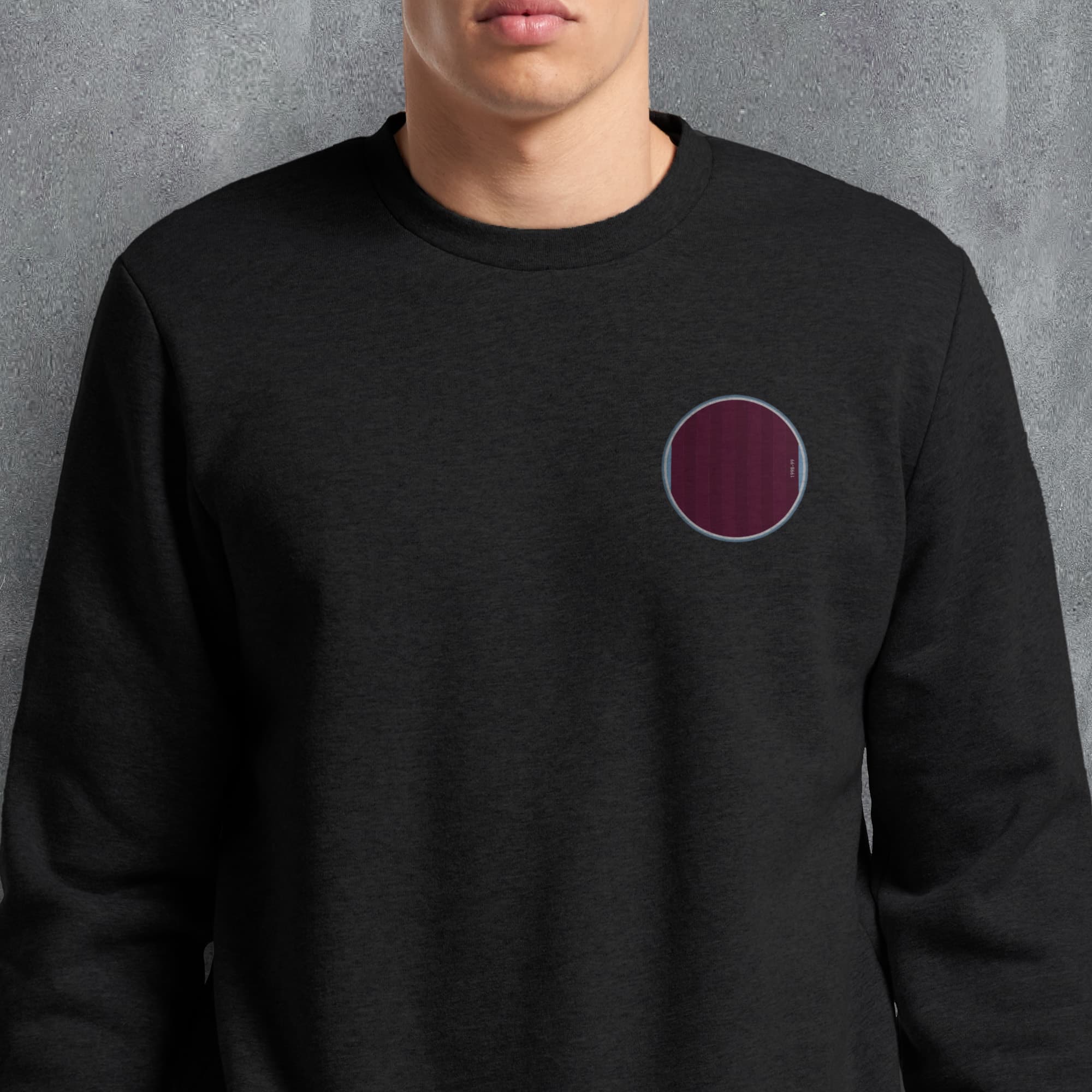 a man wearing a black sweatshirt with a red circle on it