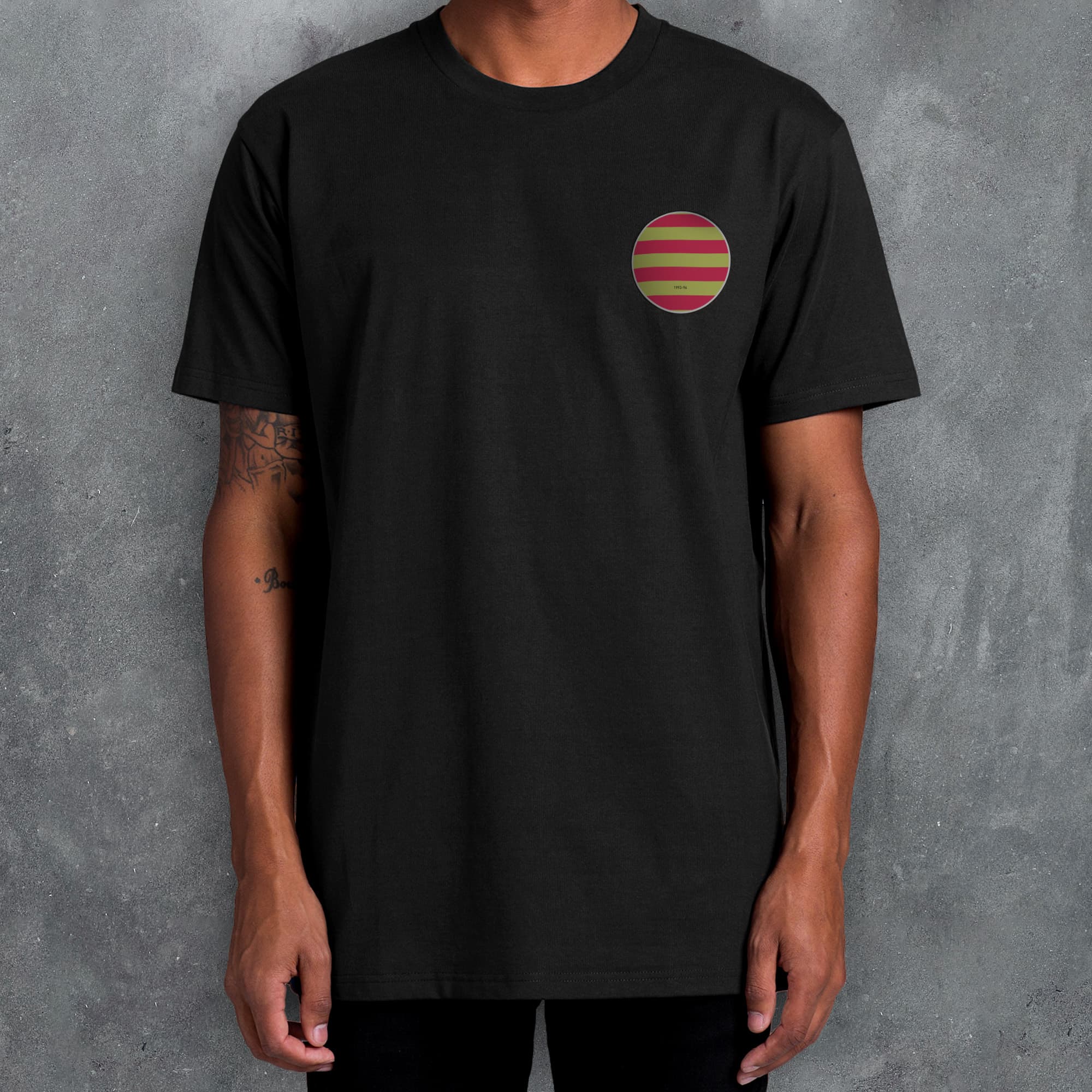 a man wearing a black t - shirt with a striped pocket