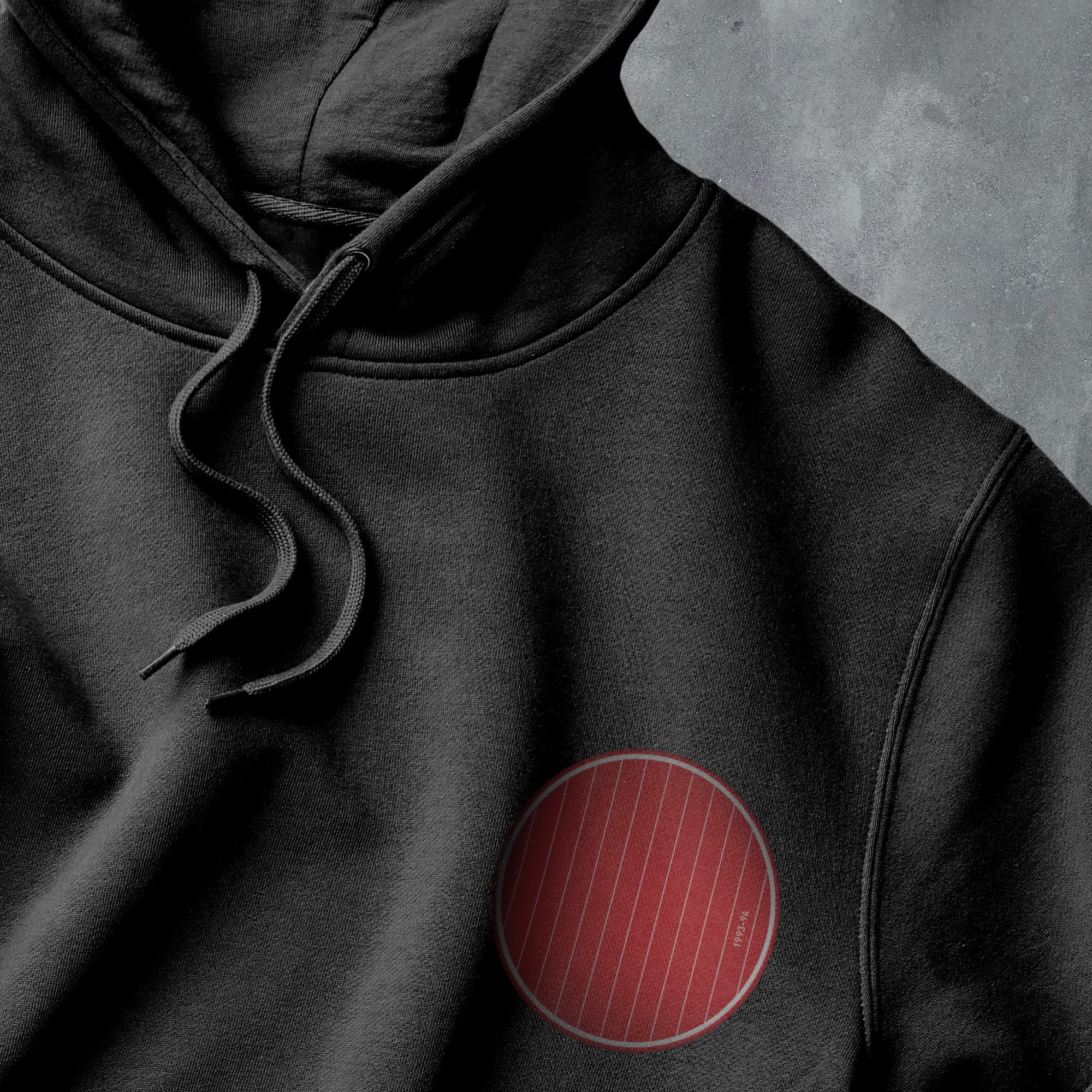 a black hoodie with a red circle on it