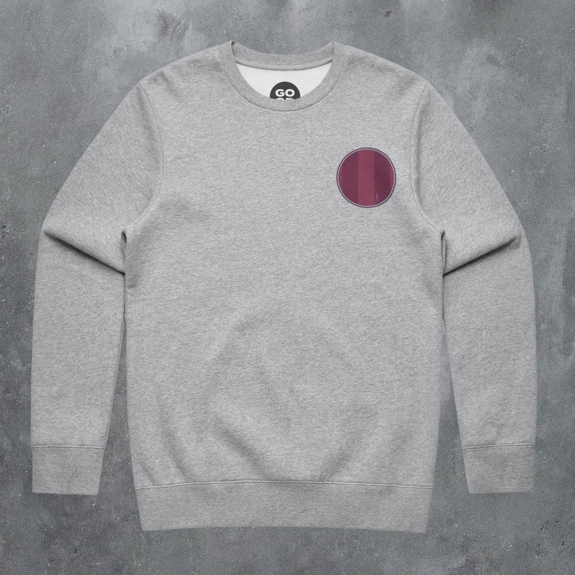 a grey sweatshirt with a red circle on it