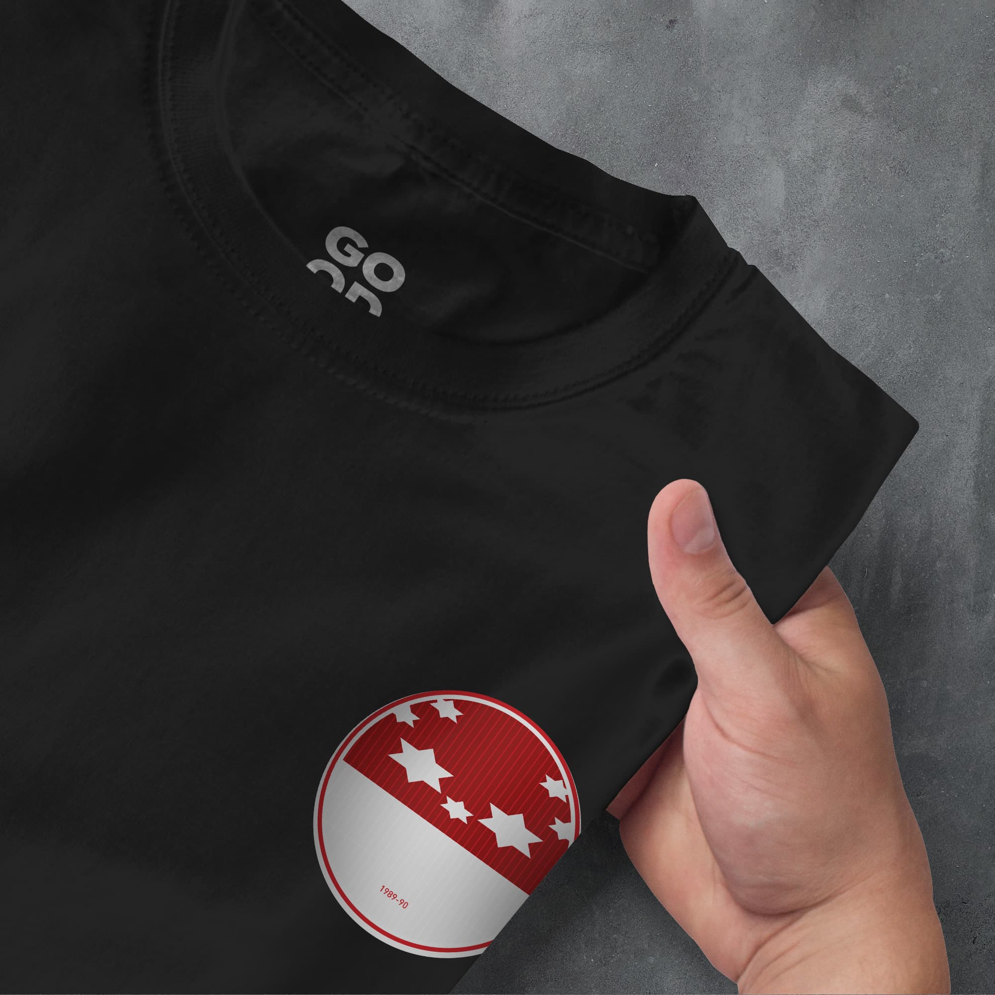 a person is holding a red and white button