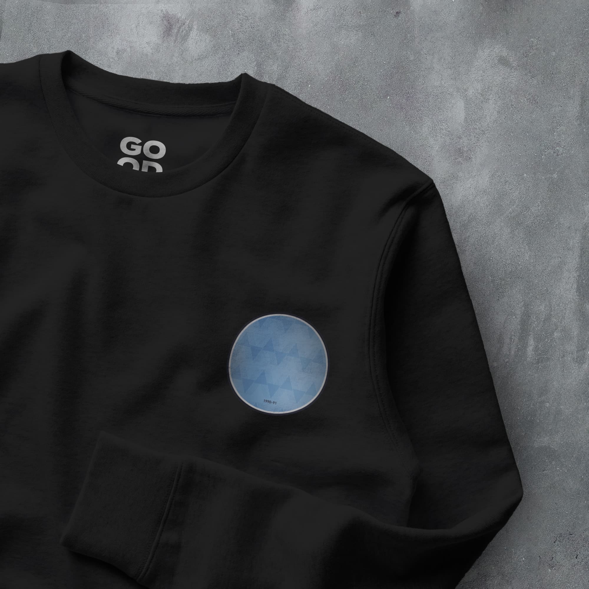 a black sweatshirt with a blue circle on it