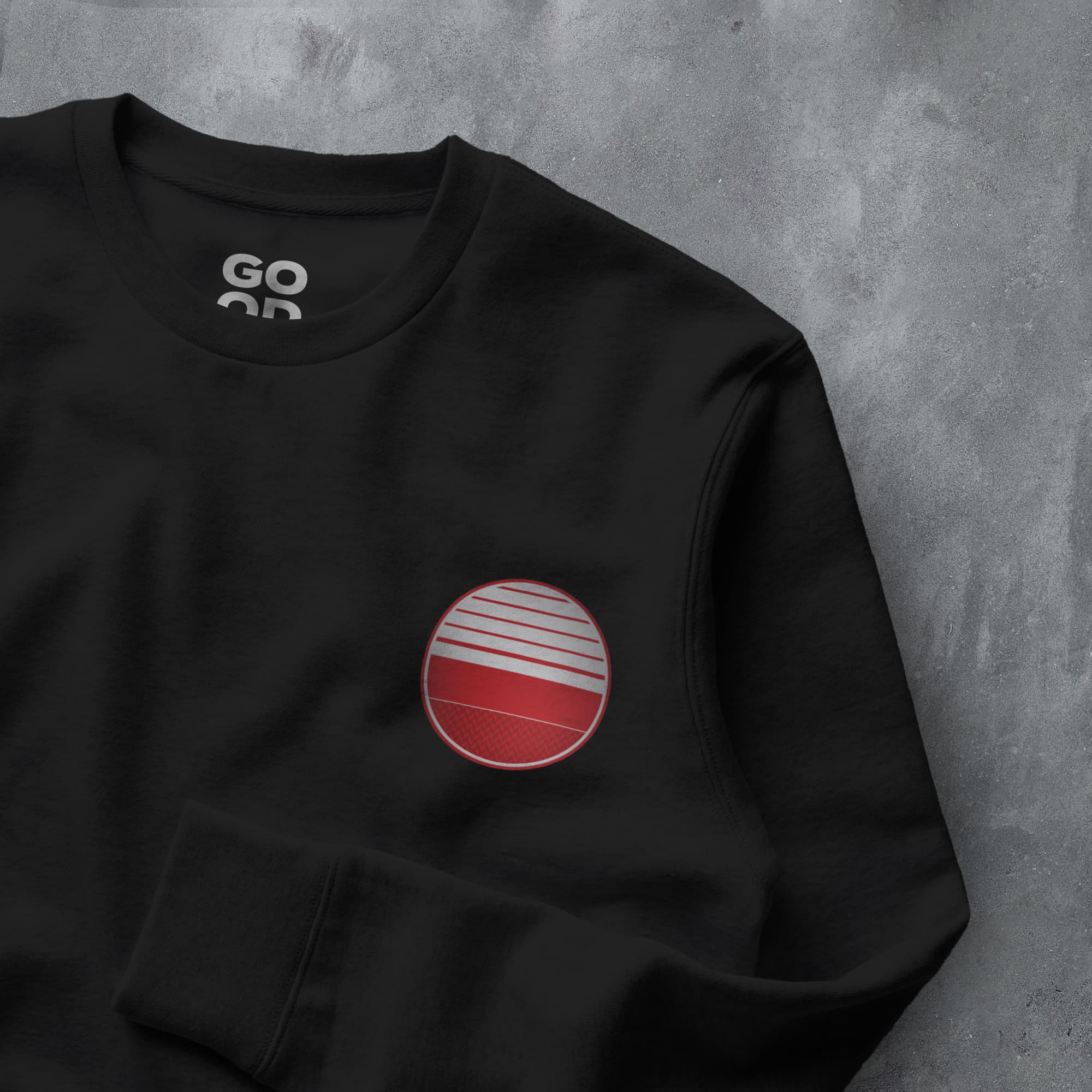 a black sweatshirt with a red and white circle on it