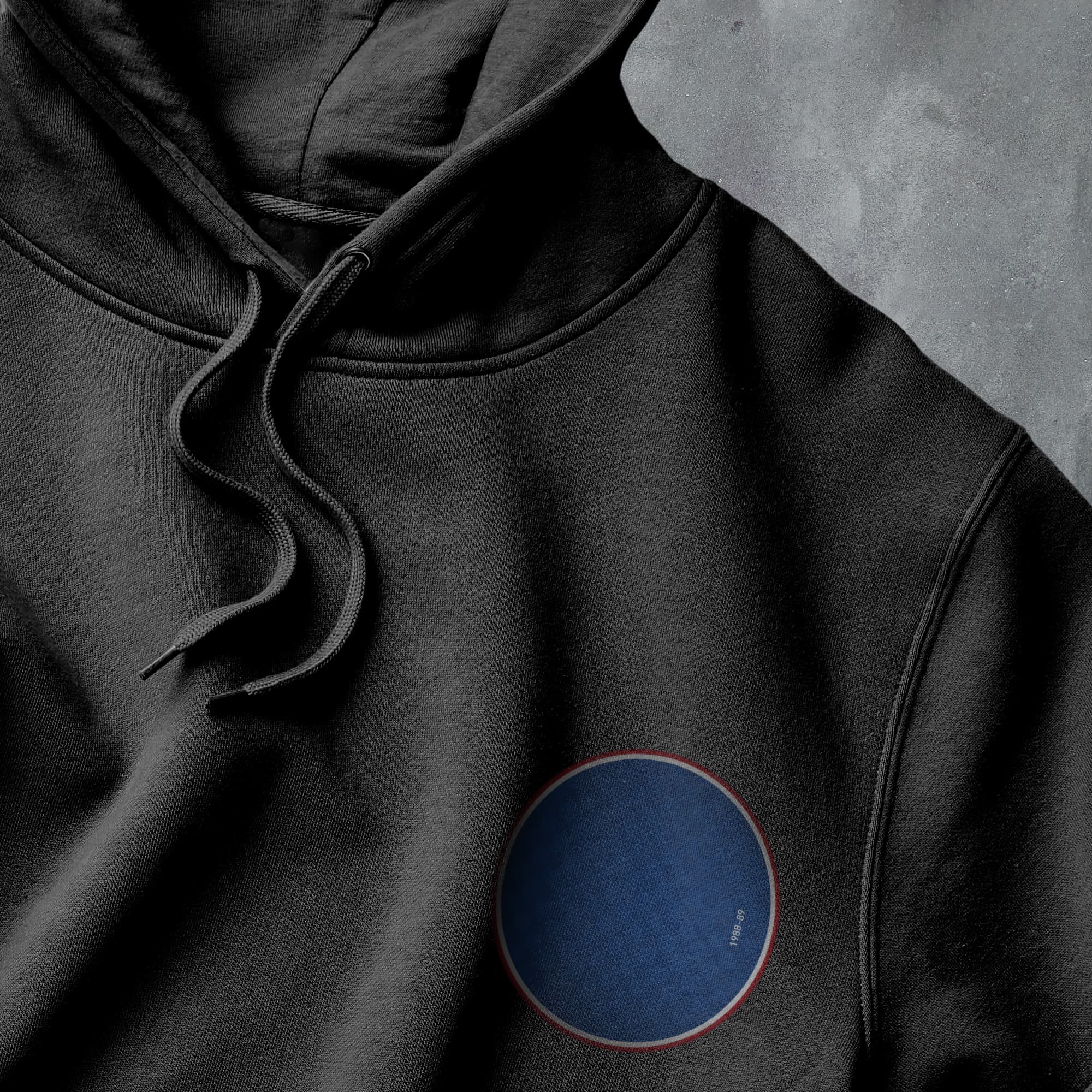 a black hoodie with a blue circle on it