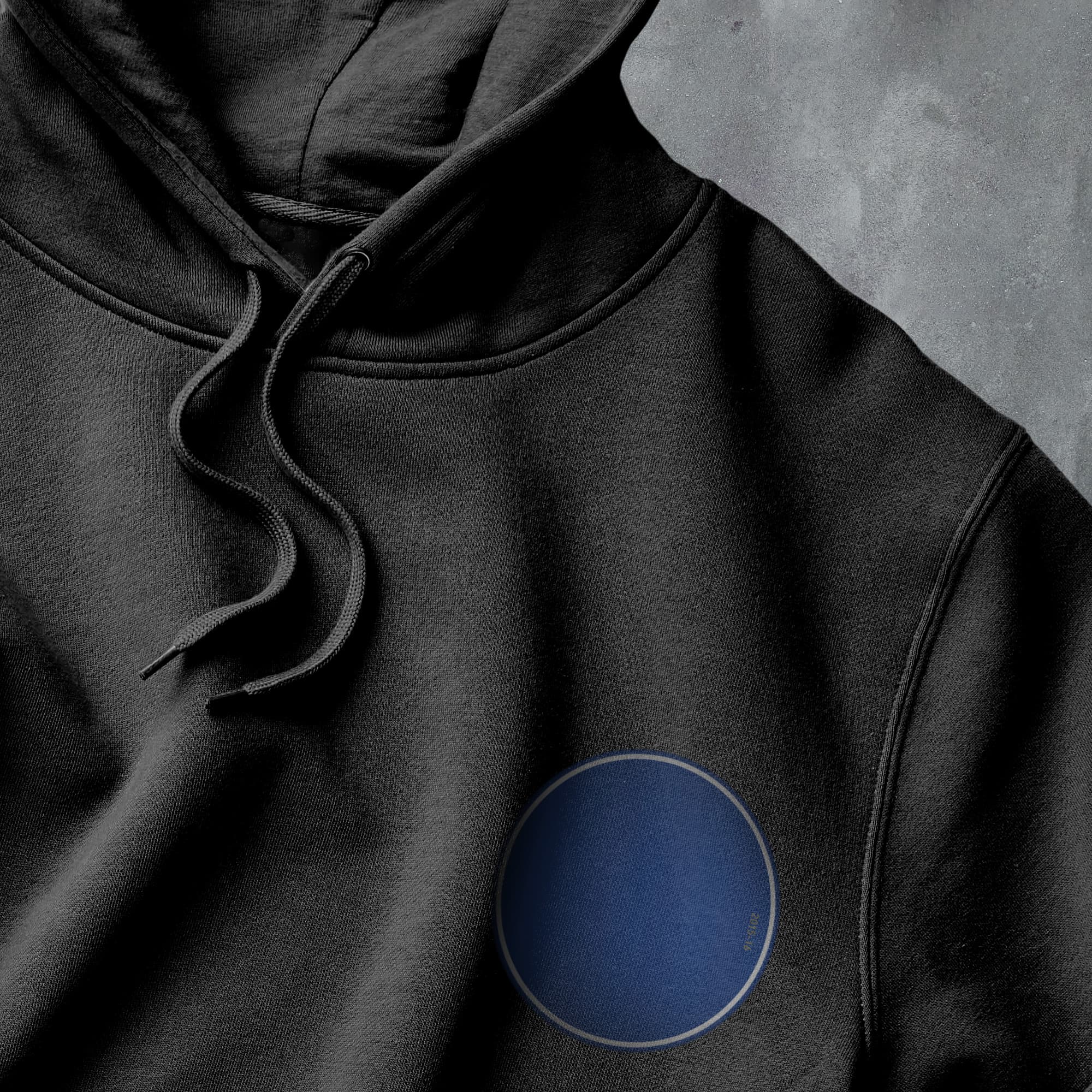 a black hoodie with a blue circle on it