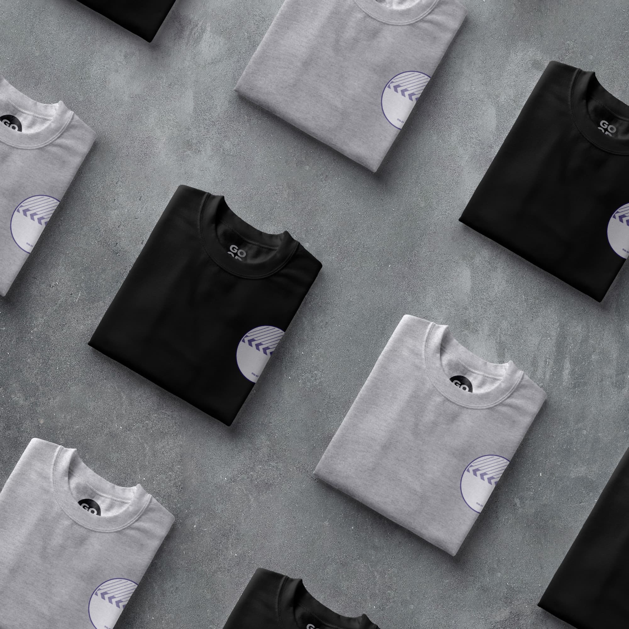 a group of t - shirts sitting on top of a cement floor