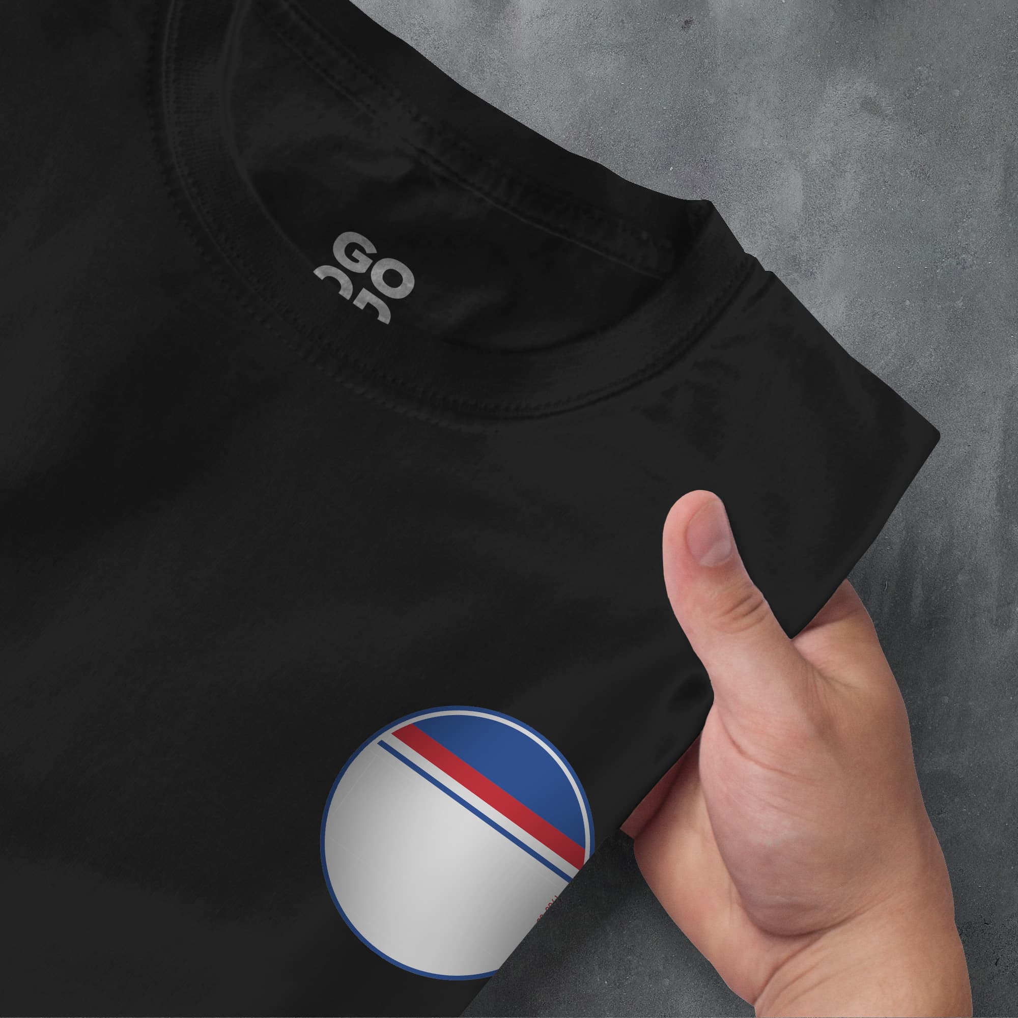 a person pointing at a black shirt with a red, white, and blue stripe