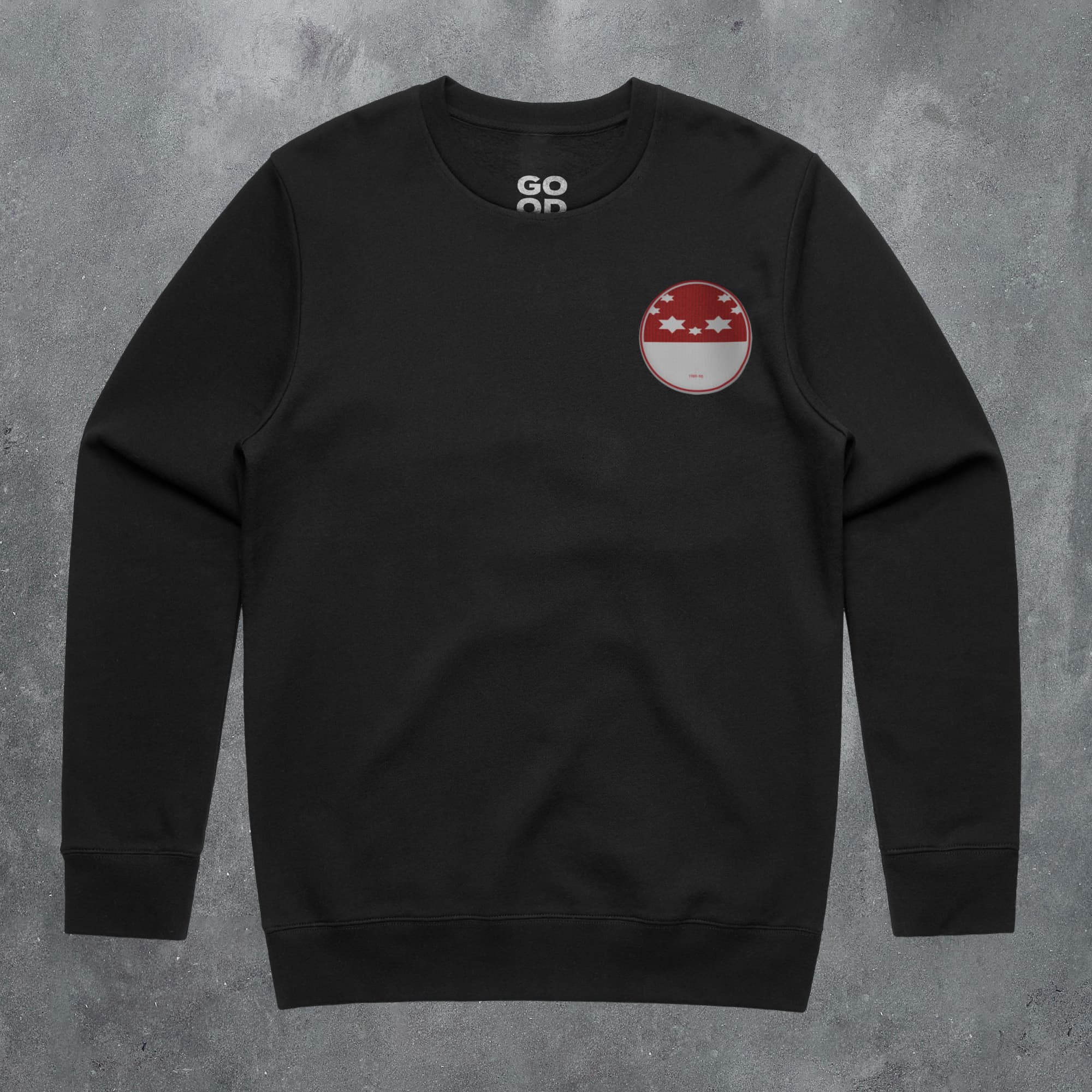 a black sweatshirt with a red and white patch on the chest