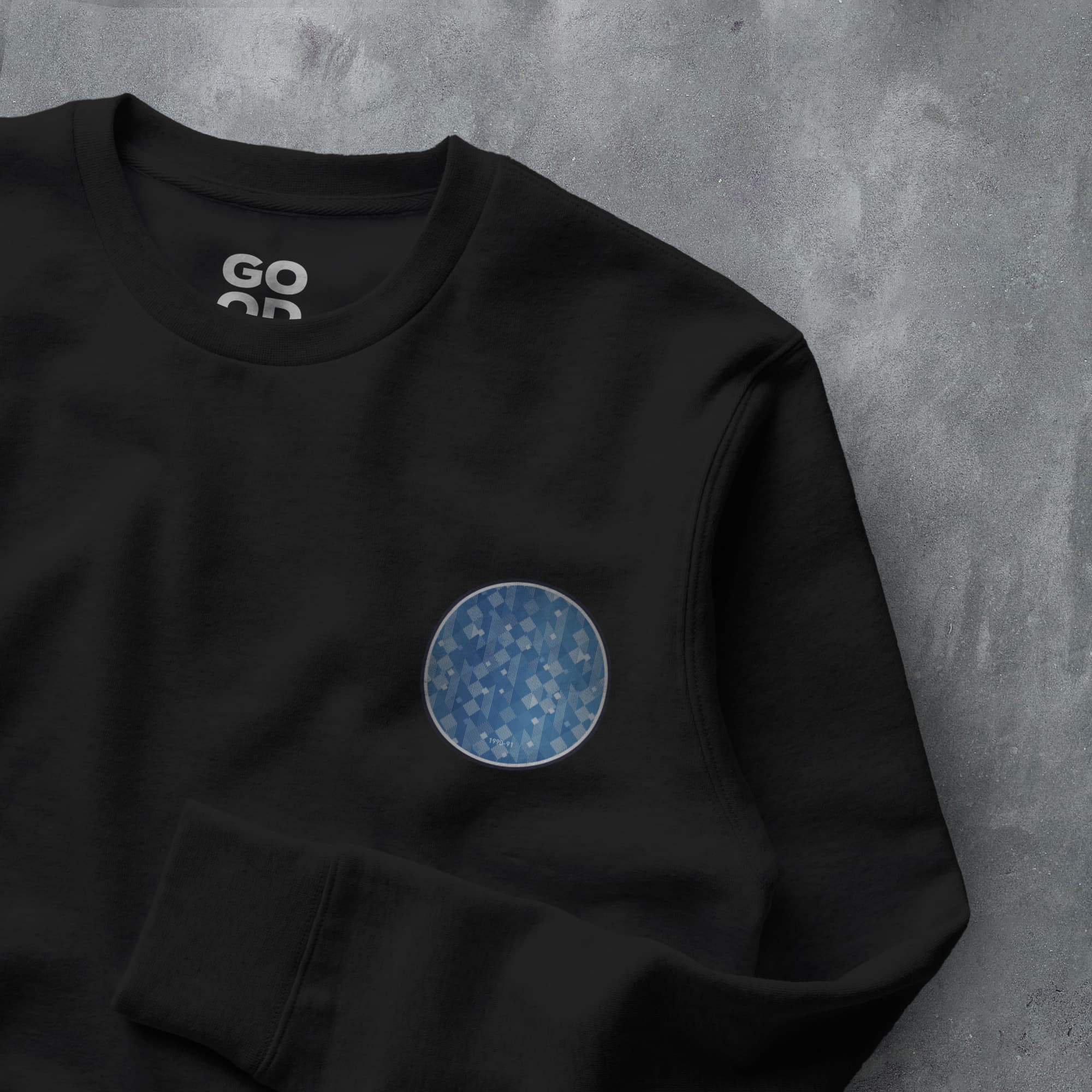 a black sweatshirt with a blue circle on it