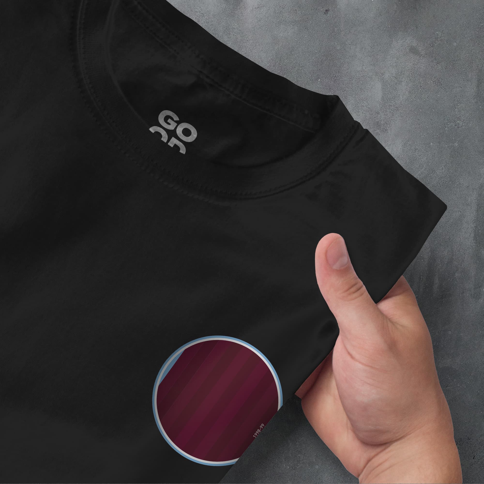 a person holding a black shirt with a red circle on it