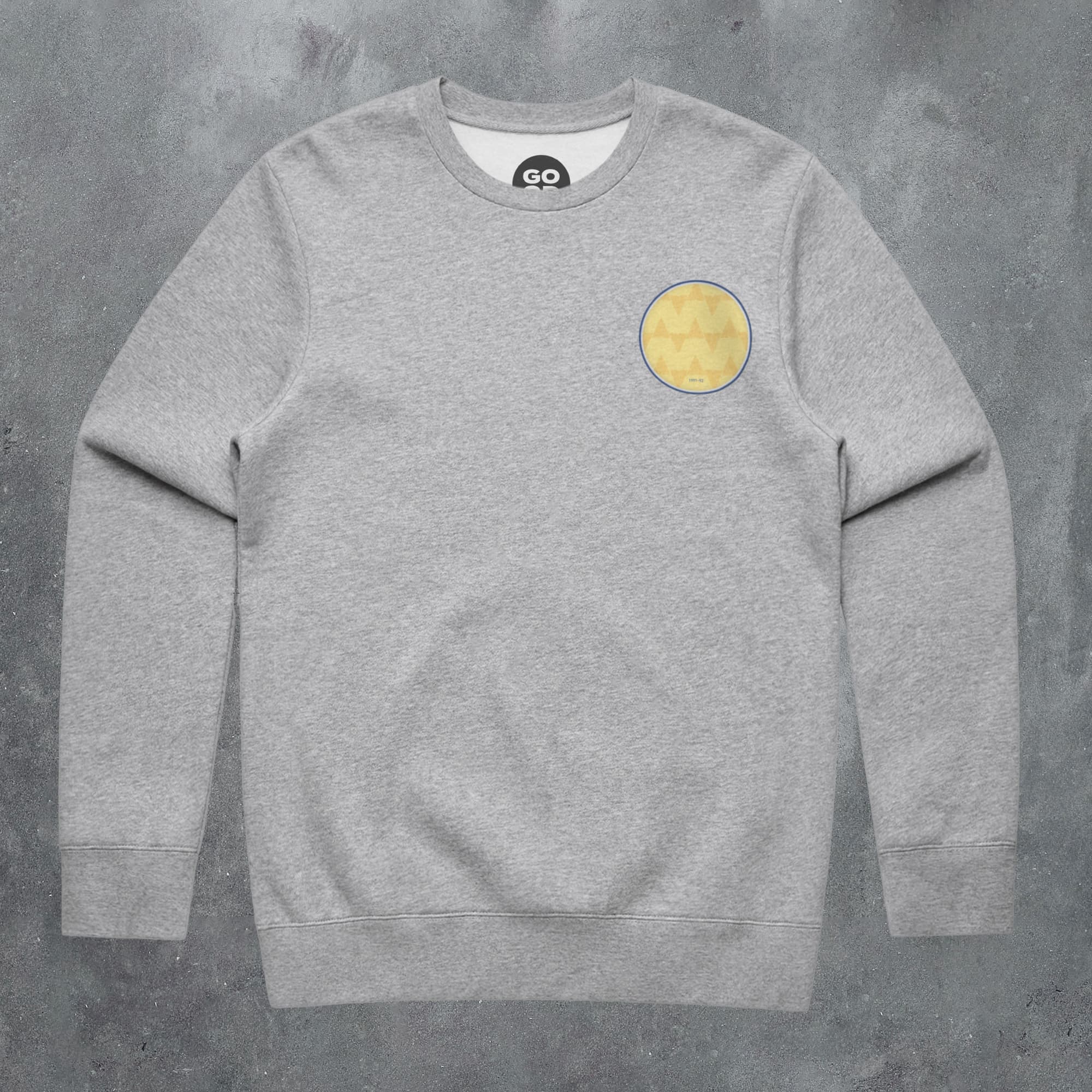 a grey sweatshirt with a yellow circle on the chest