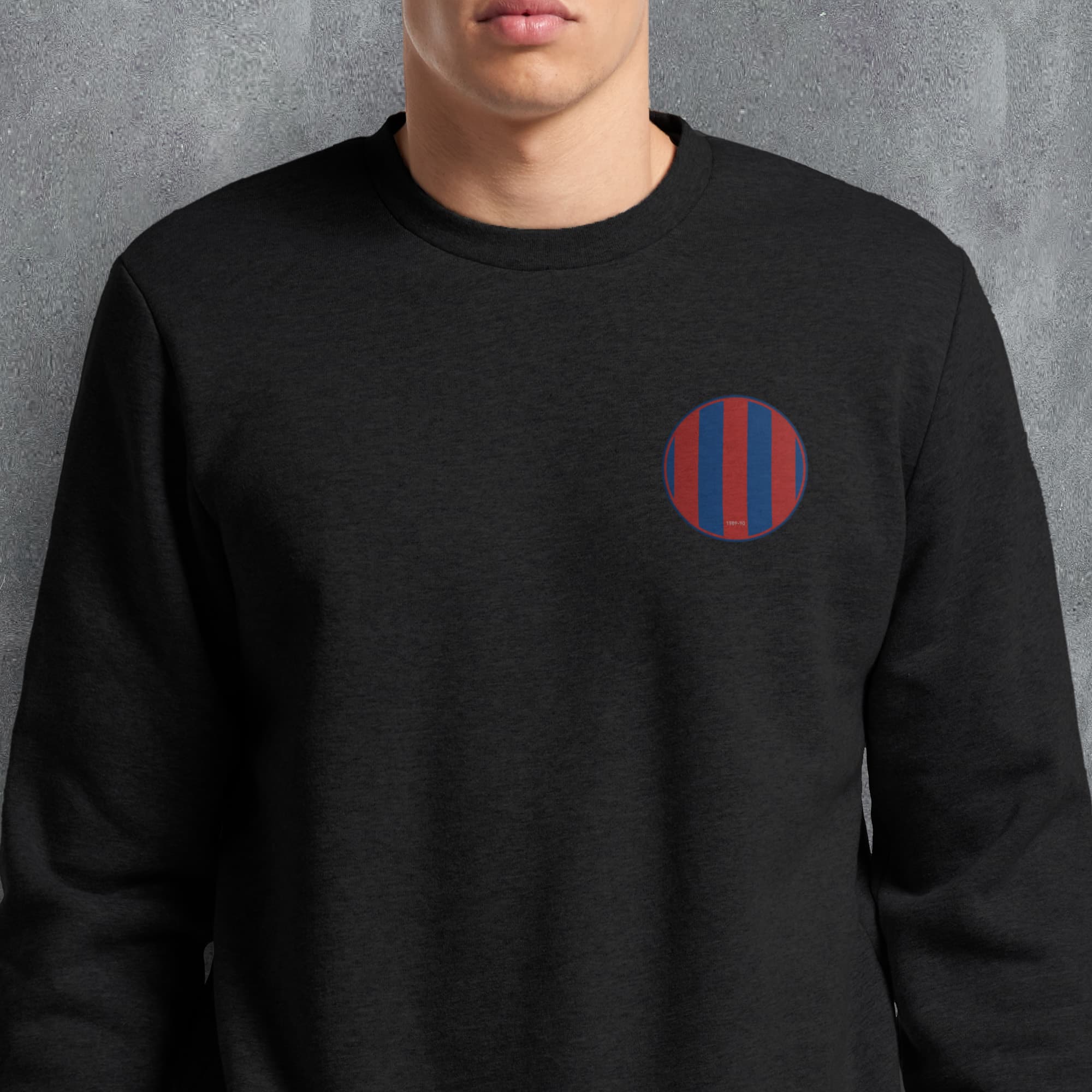 a man wearing a black sweatshirt with a red and blue circle on it