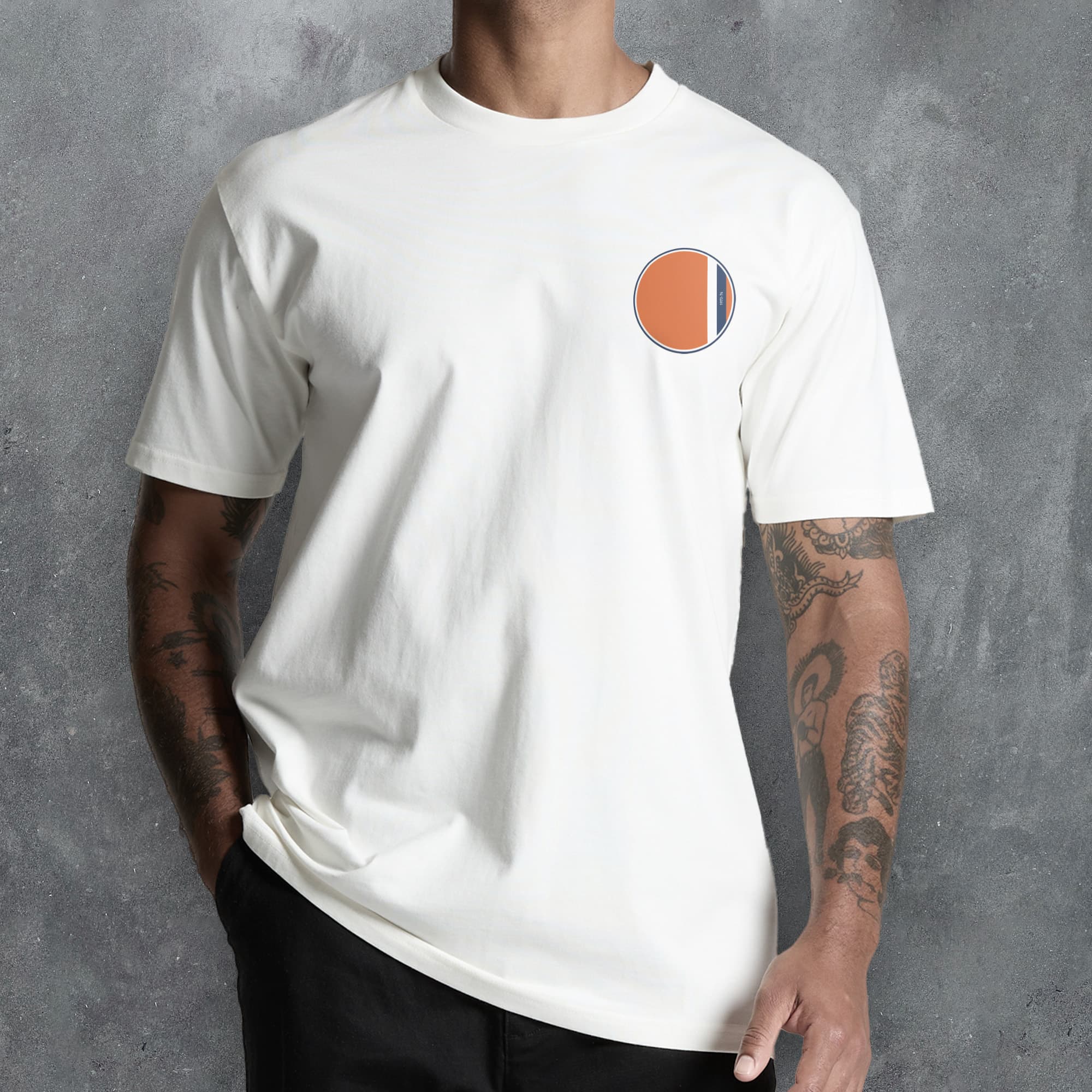 a man wearing a white t - shirt with an orange circle on it