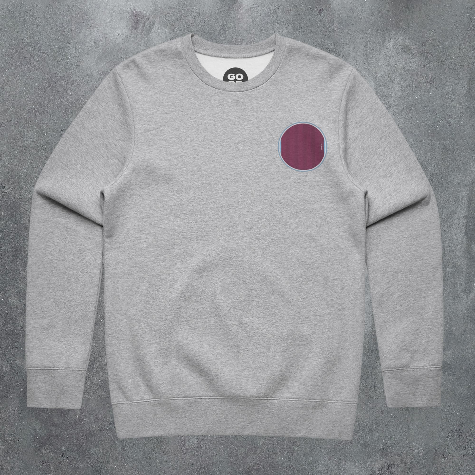 a grey sweatshirt with a red circle on the front