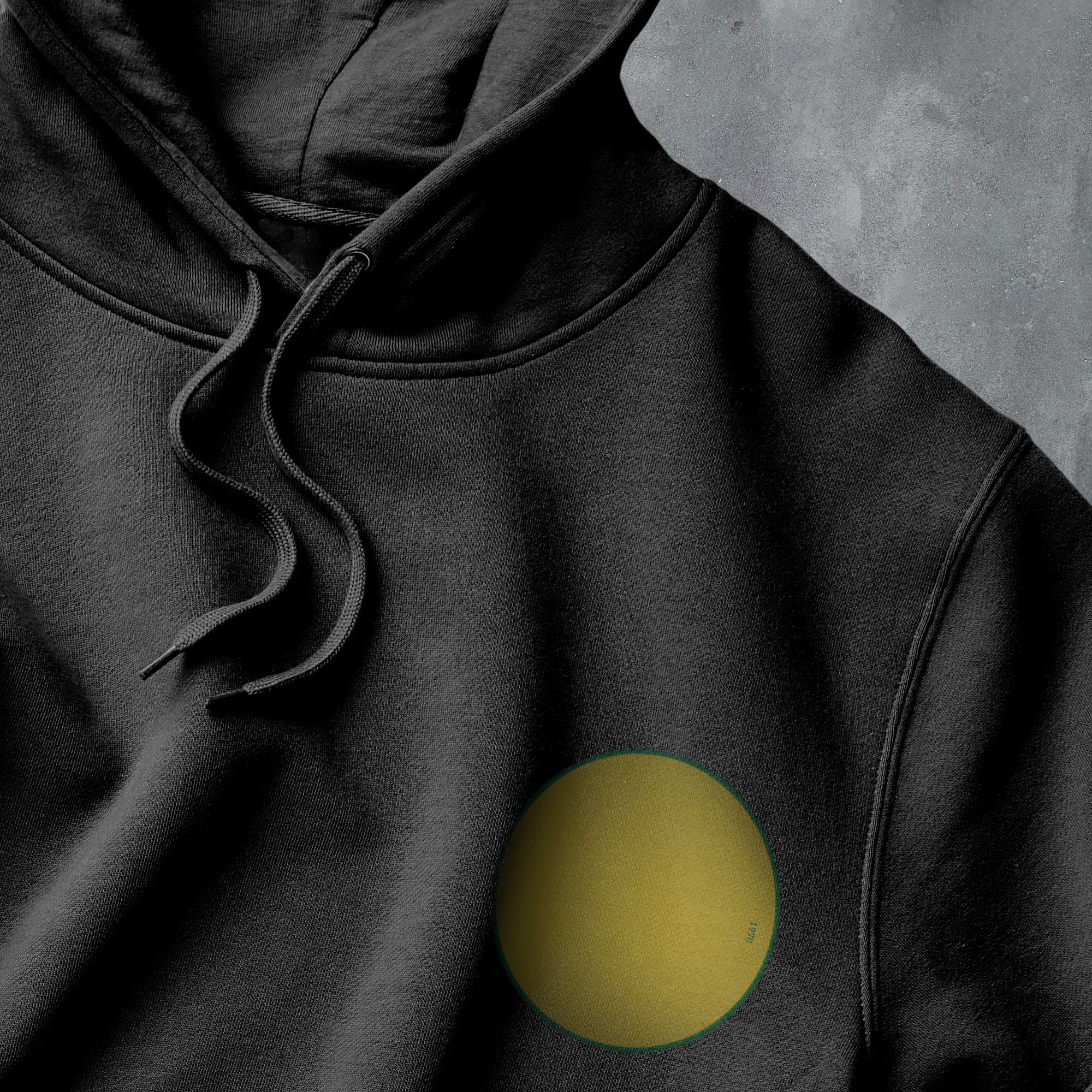 a black hoodie with a yellow circle on it