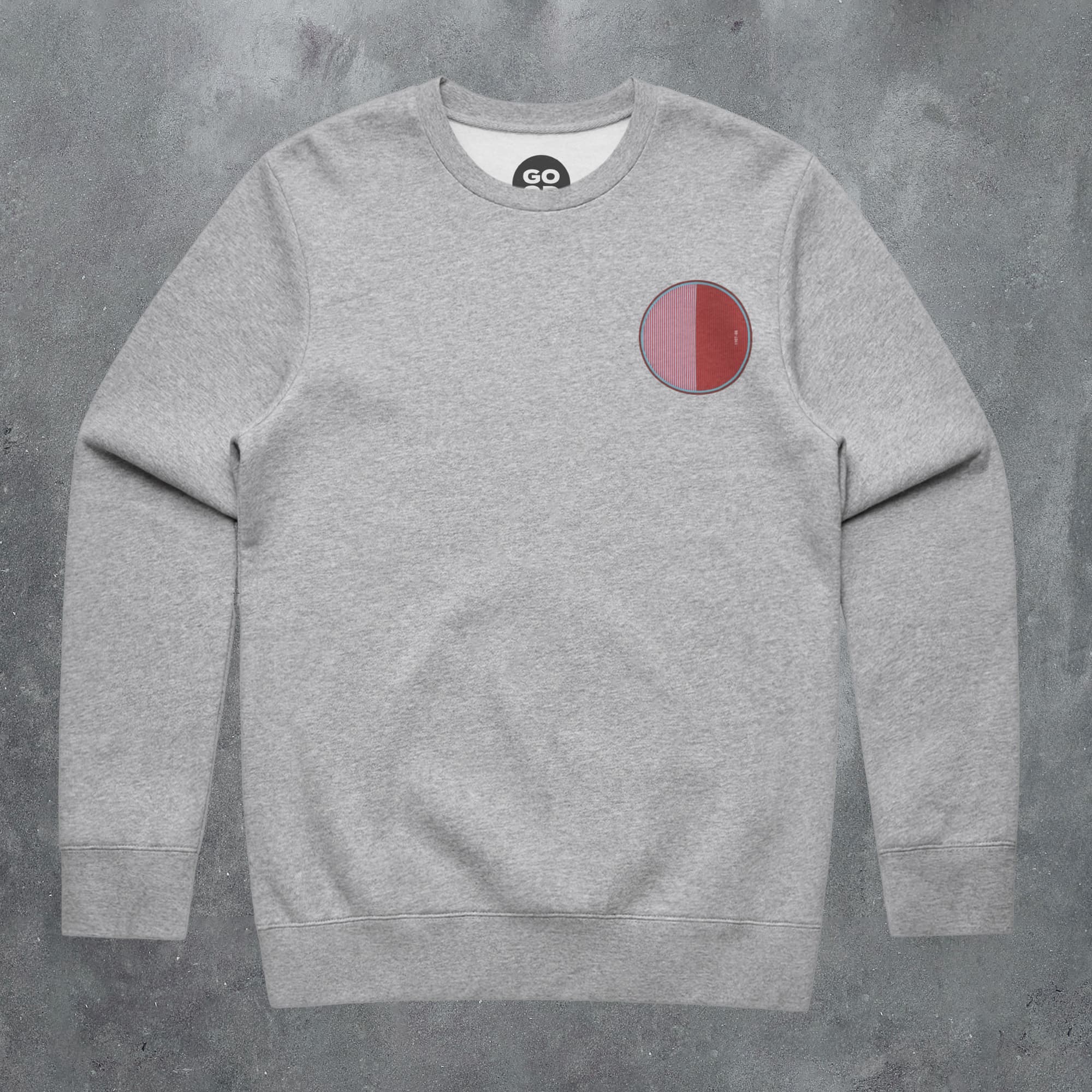 a grey sweatshirt with a red circle on it