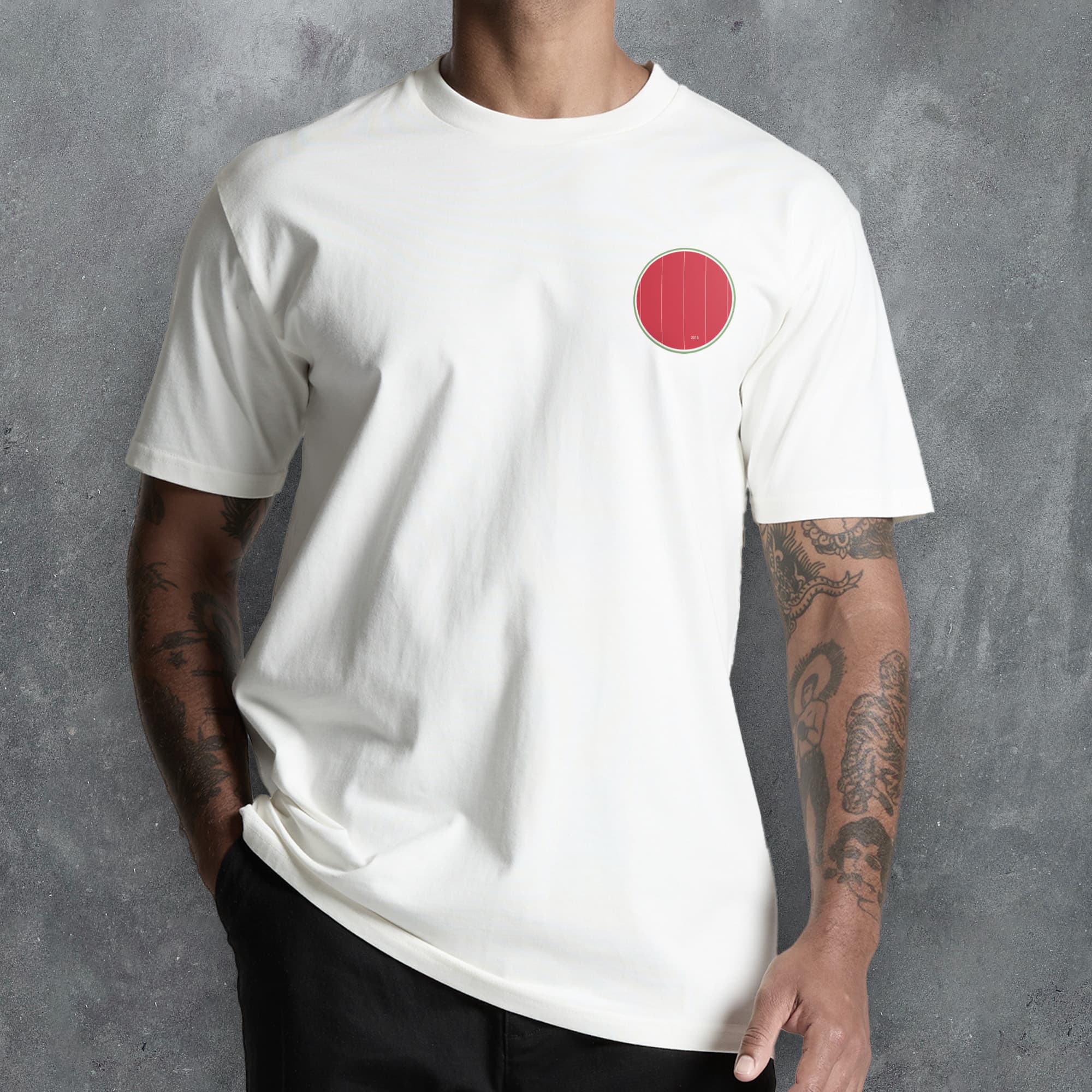 a man wearing a white t - shirt with a red circle on it