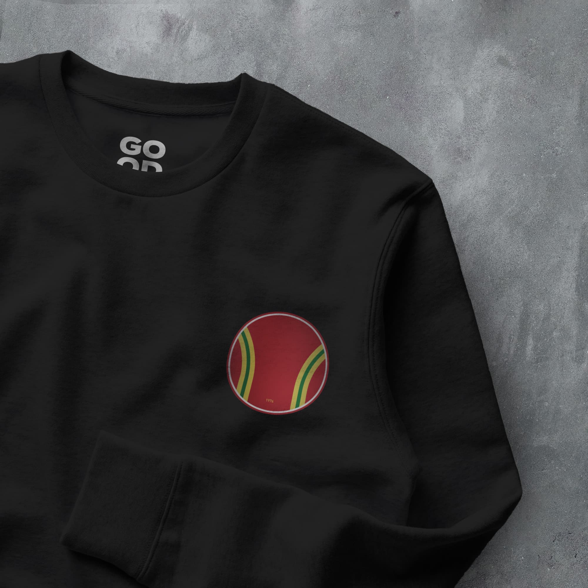 a black sweatshirt with a red and green tennis ball on it