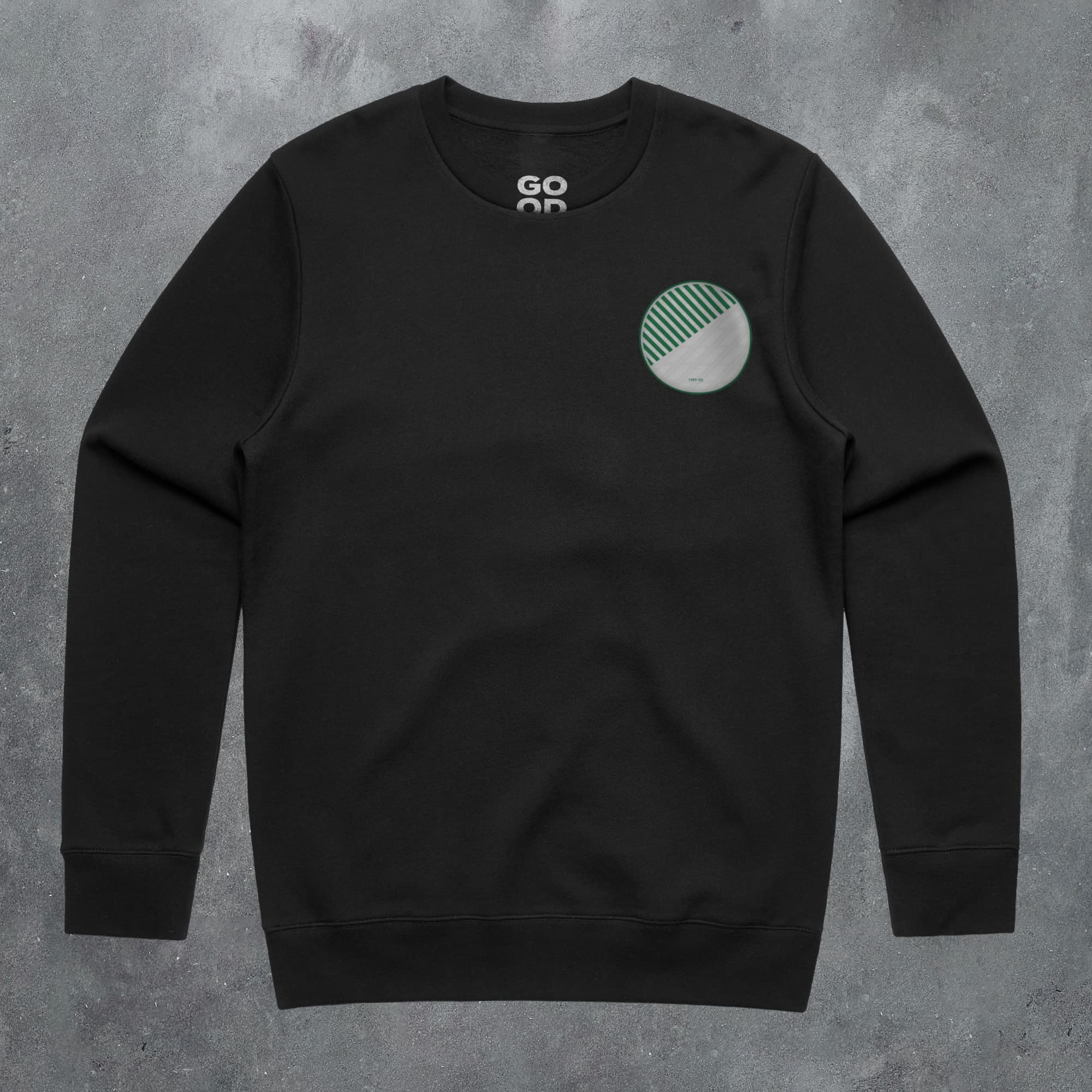 a black sweatshirt with a green circle on the chest