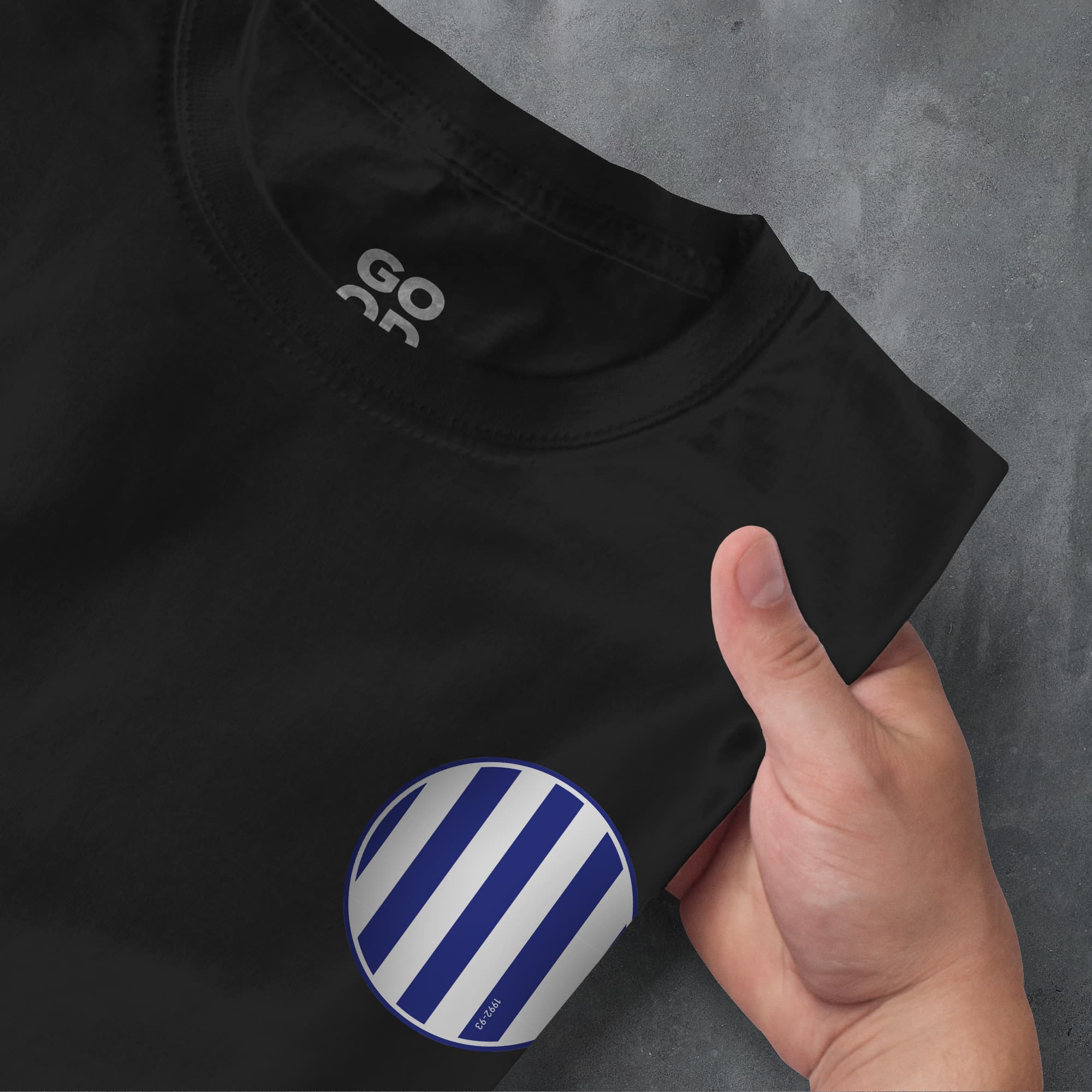a person pointing at a black shirt with blue and white stripes