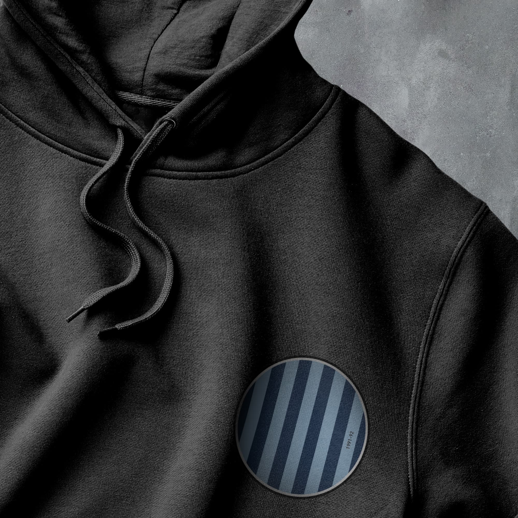 a black hoodie with a striped patch on it