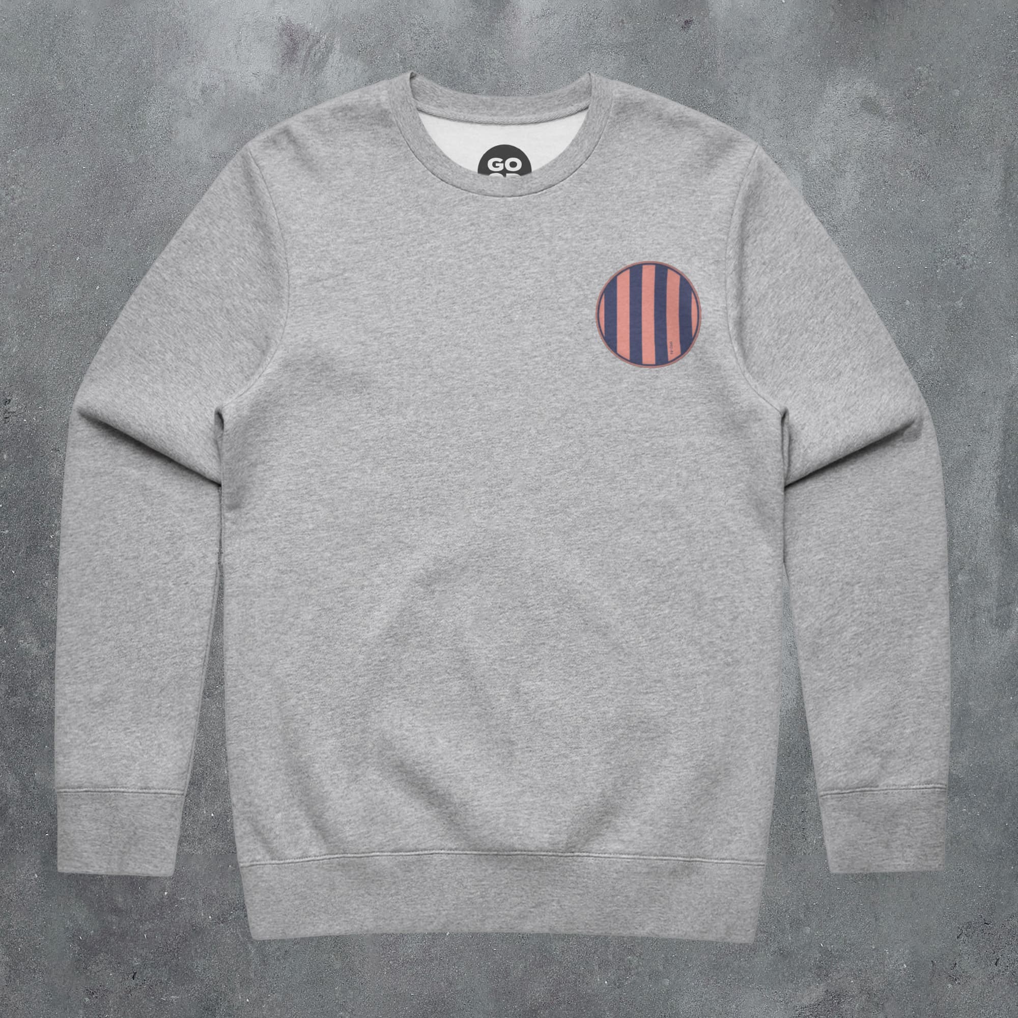 a grey sweatshirt with a red and blue stripe on the chest