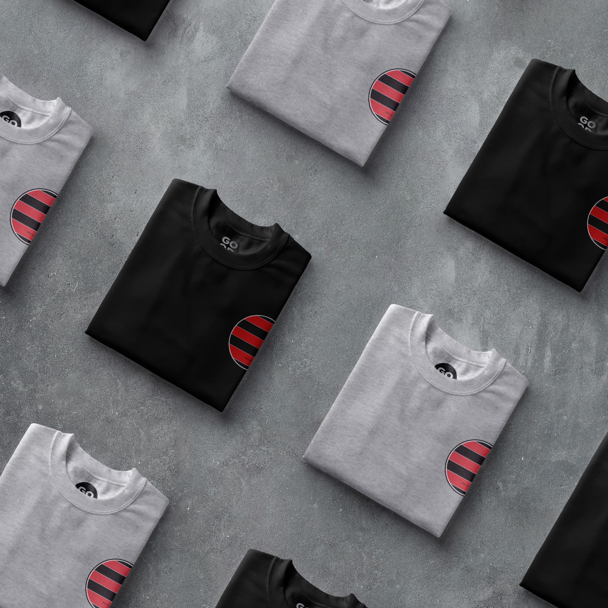 a group of black and grey t - shirts with red stripes