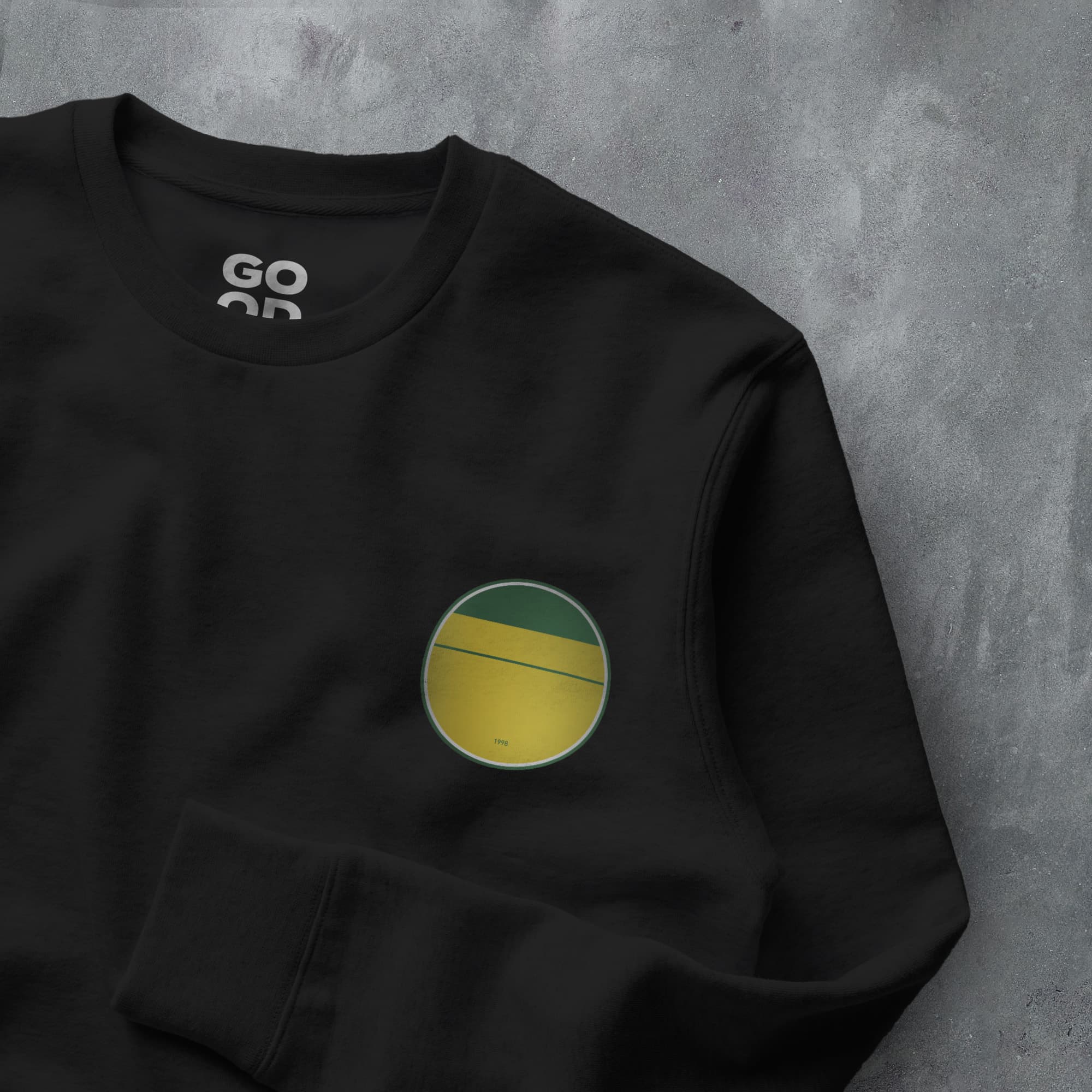 a black sweatshirt with a green and yellow circle on it