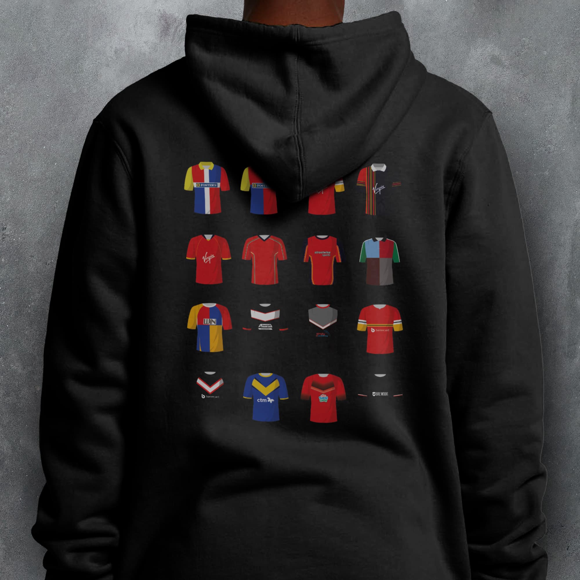 a person wearing a black hoodie with a bunch of different colored shirts on it