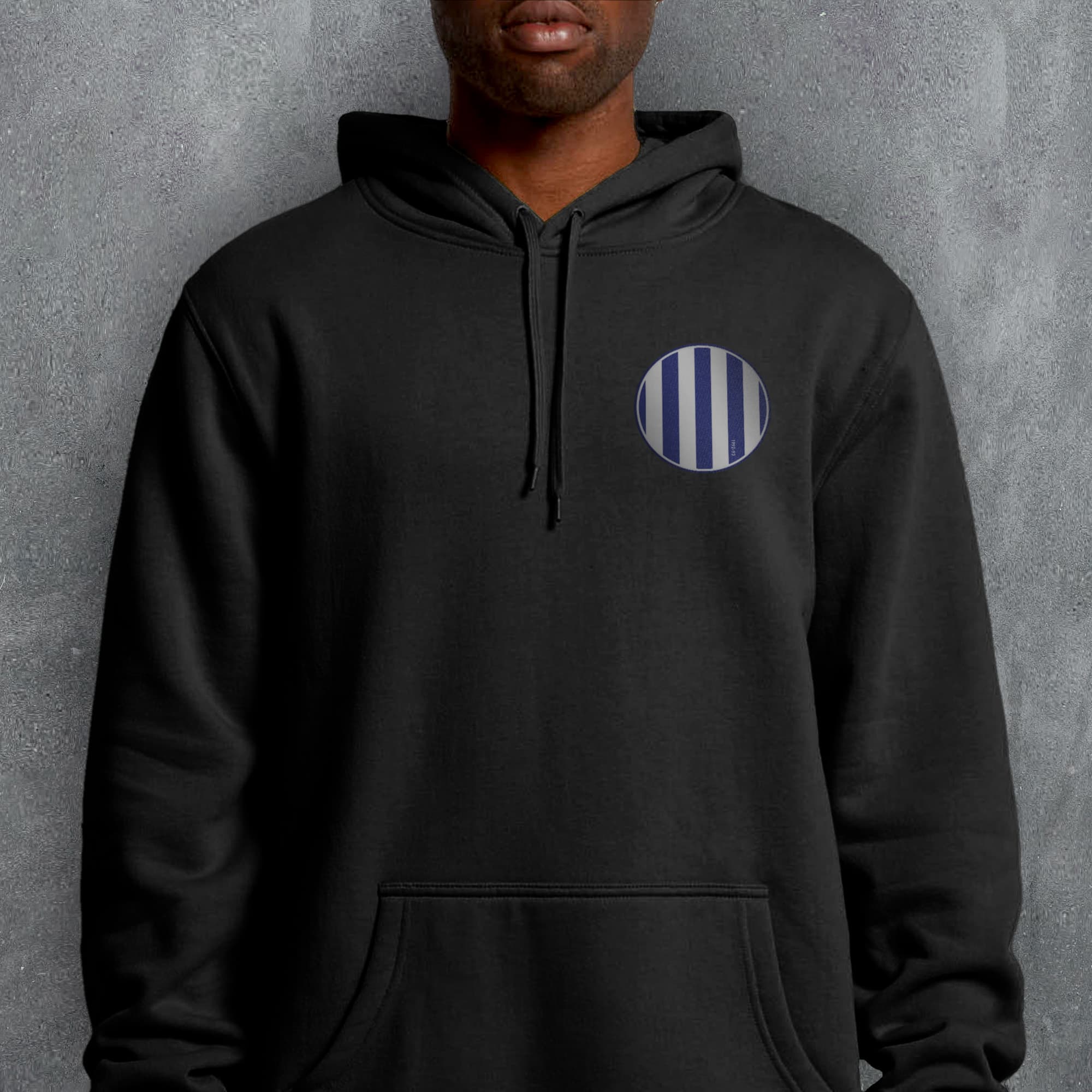 a man wearing a black hoodie with a blue and white stripe on it