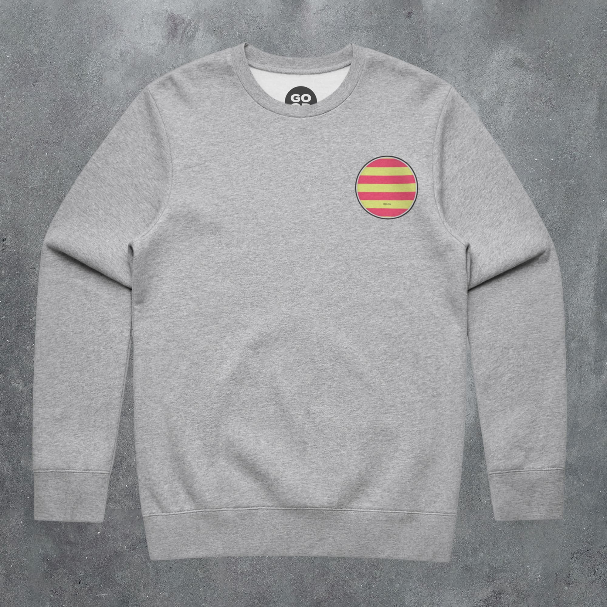 a grey sweatshirt with a red and yellow stripe on the chest