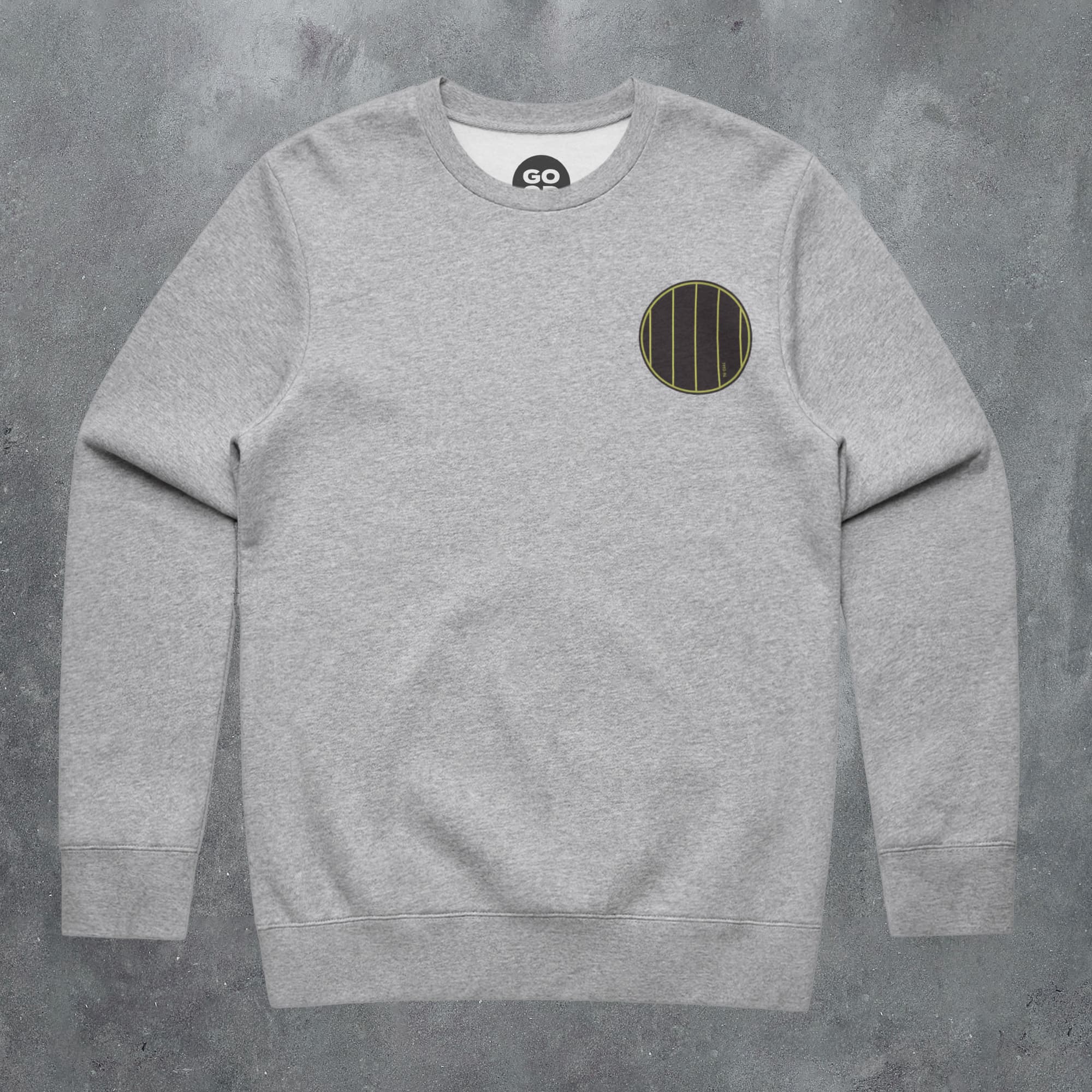 a grey sweatshirt with a round patch on the chest