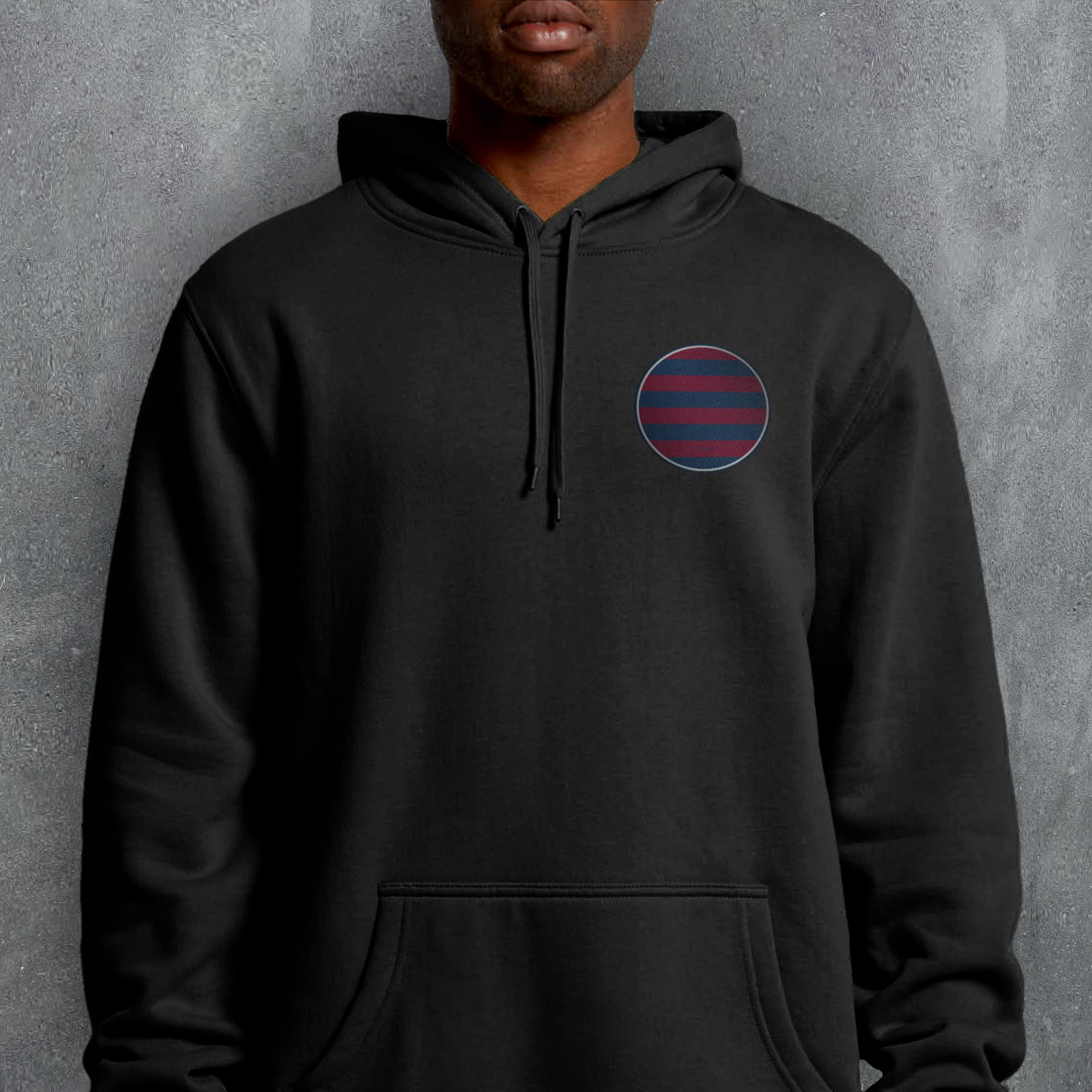 a man wearing a black hoodie with a red and blue circle on it
