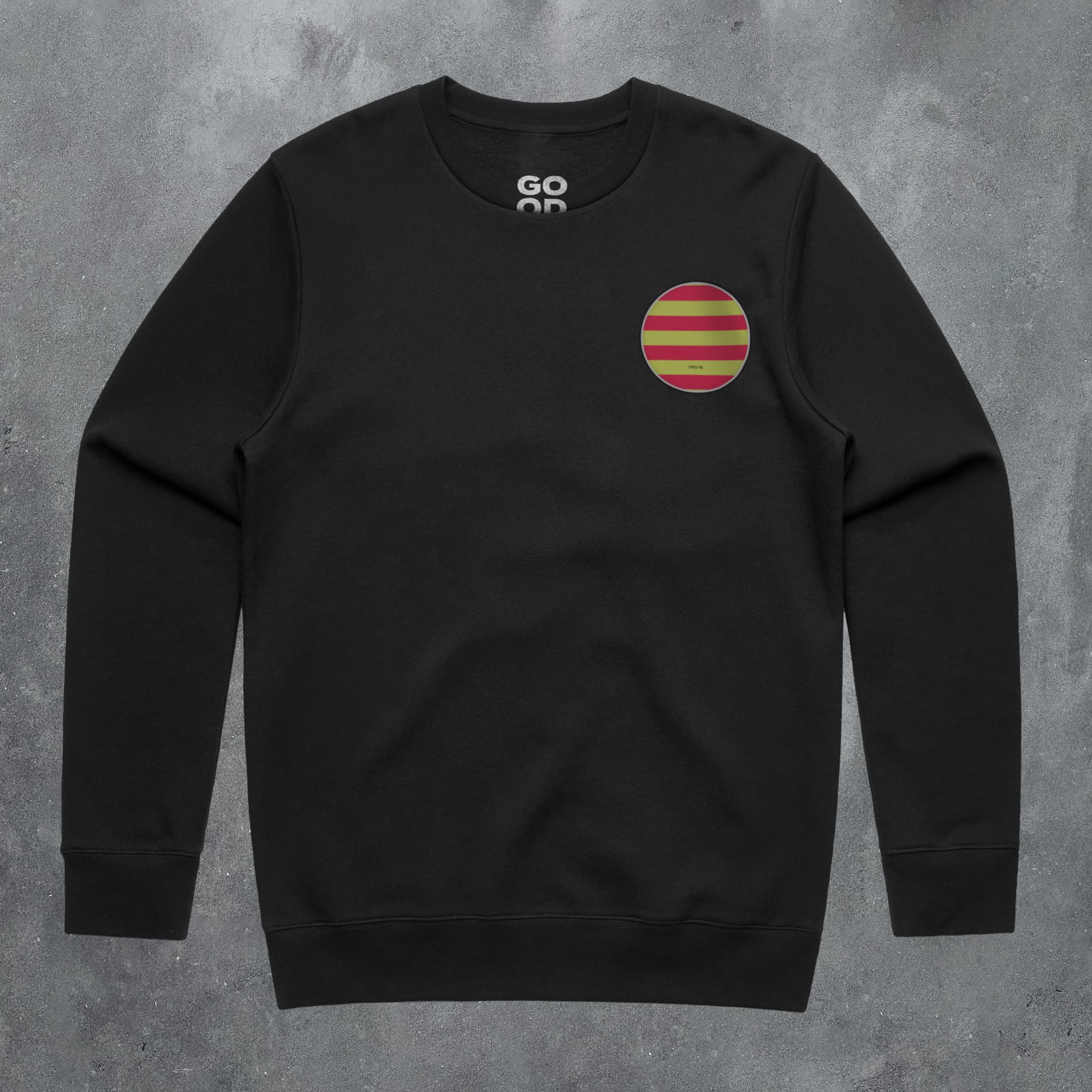 a black sweatshirt with a red and yellow striped circle on it