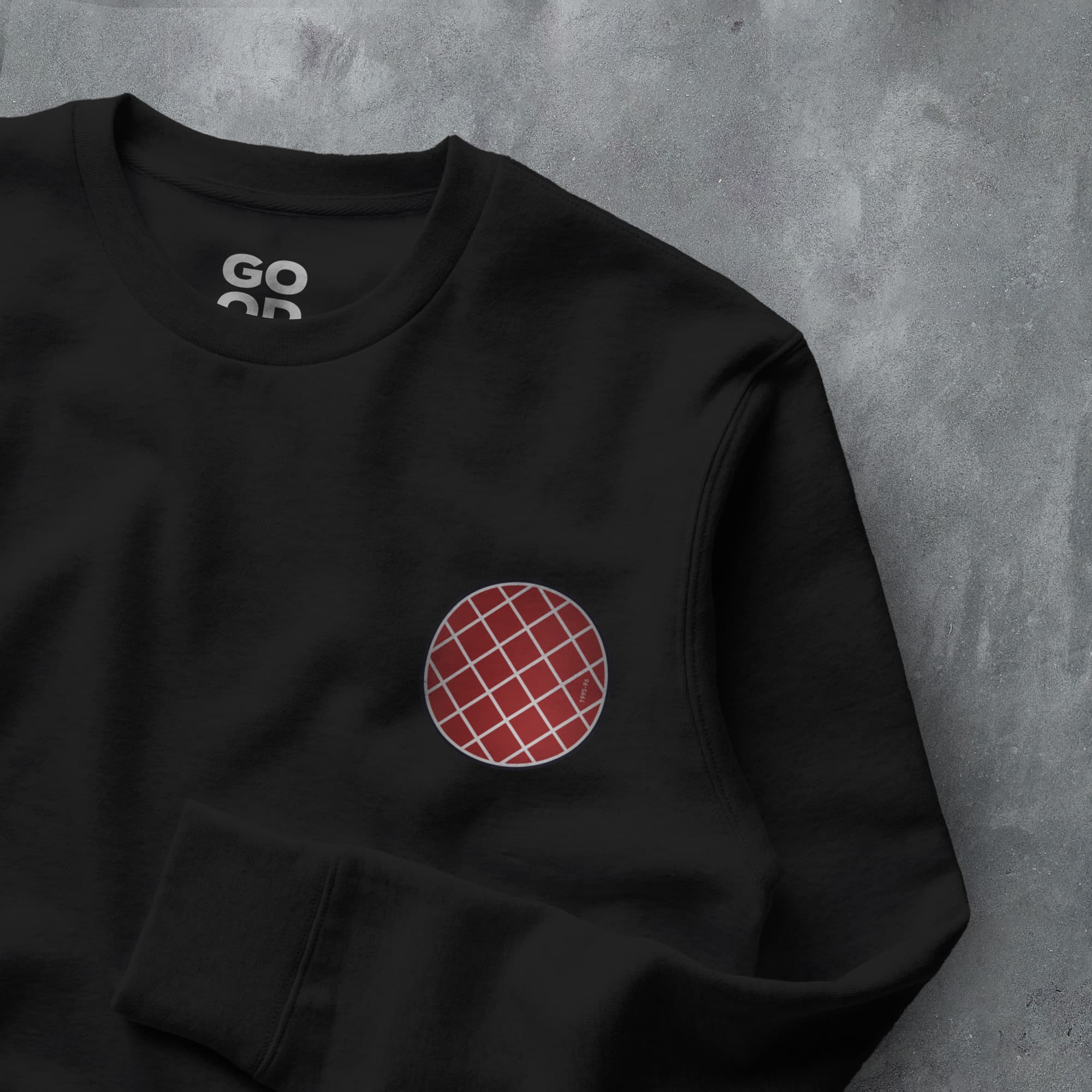 a black sweatshirt with a red and white patch on it