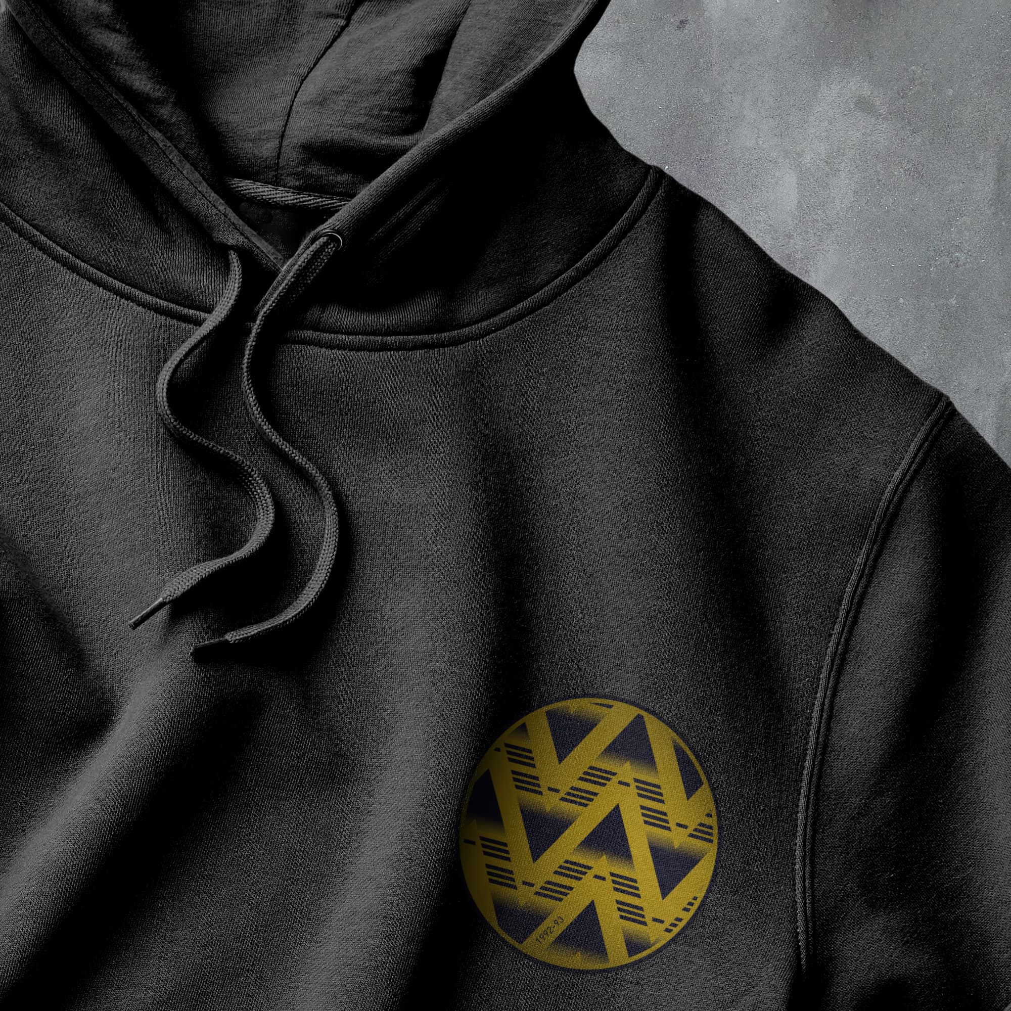 a black hoodie with a yellow logo on it