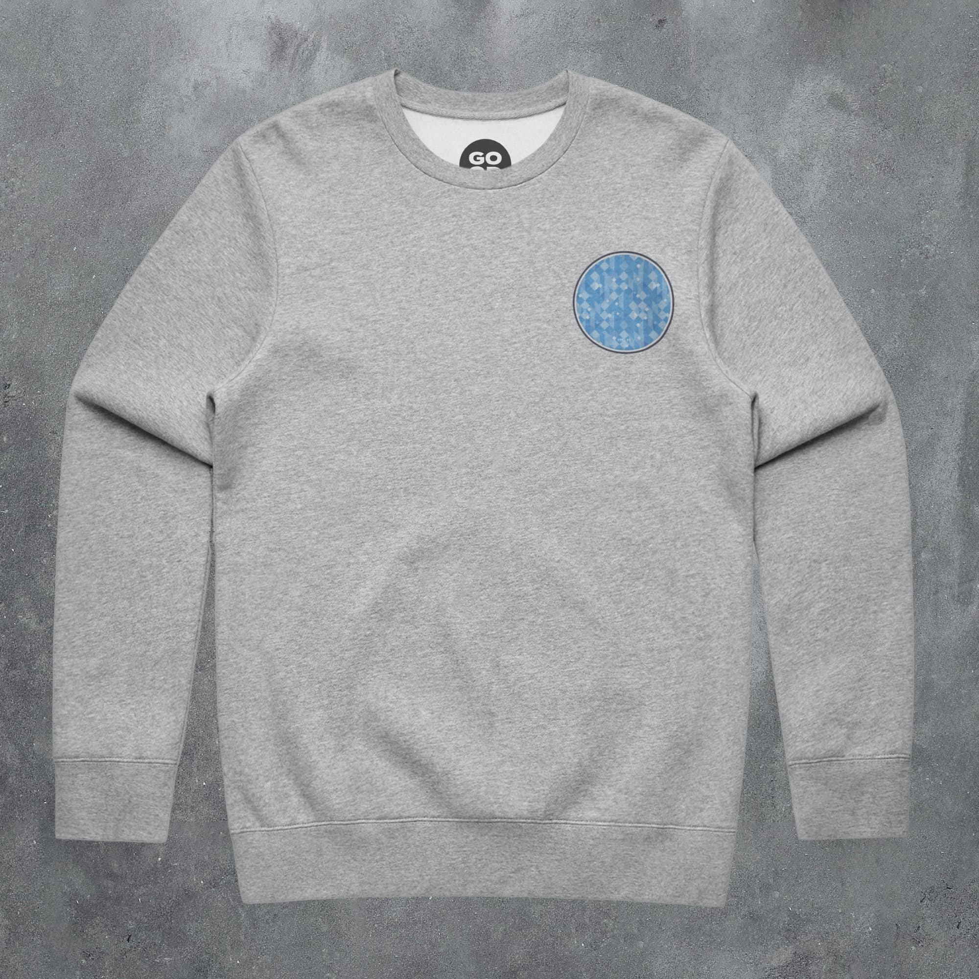a grey sweatshirt with a blue circle on the front