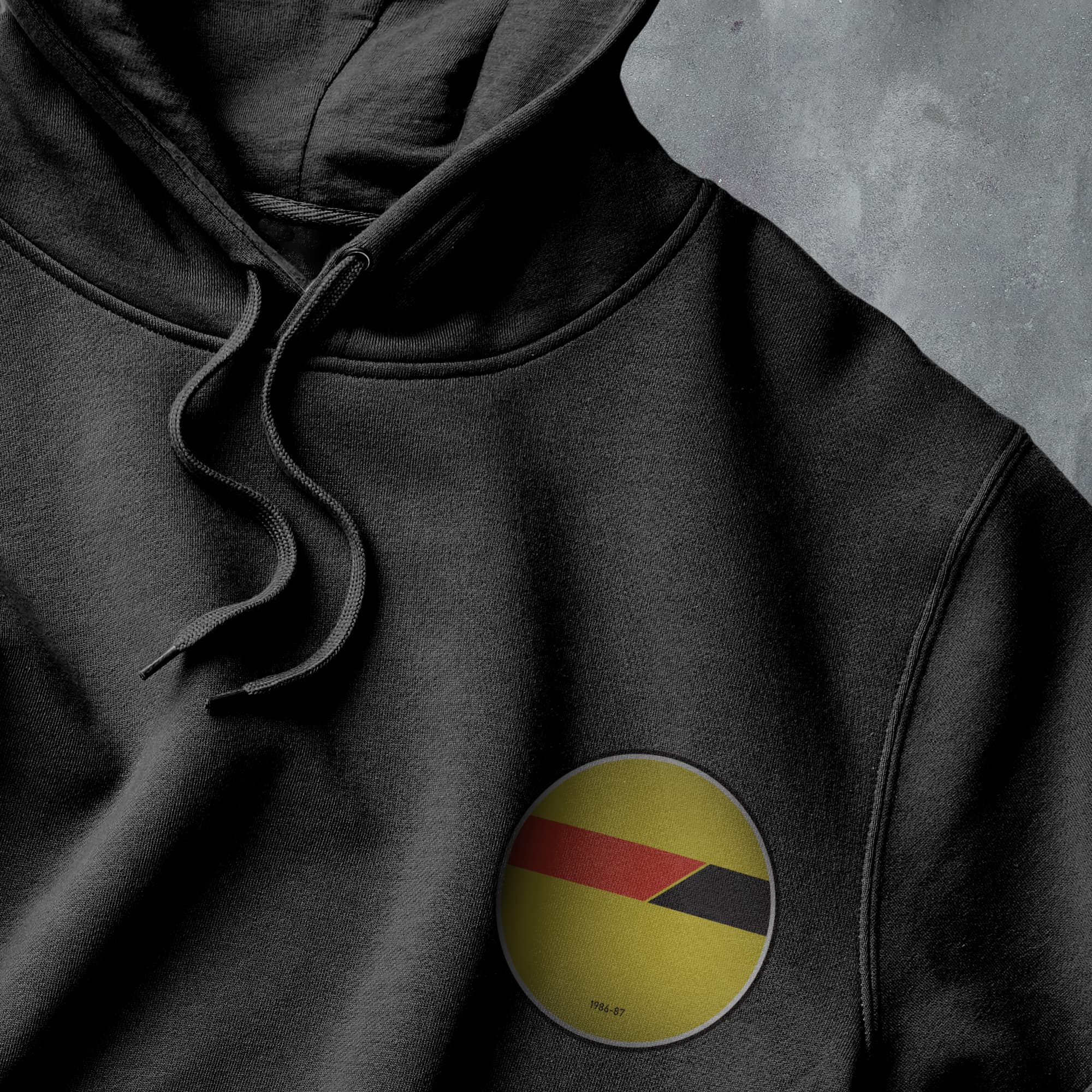 a black hoodie with a red, yellow, and black stripe on it