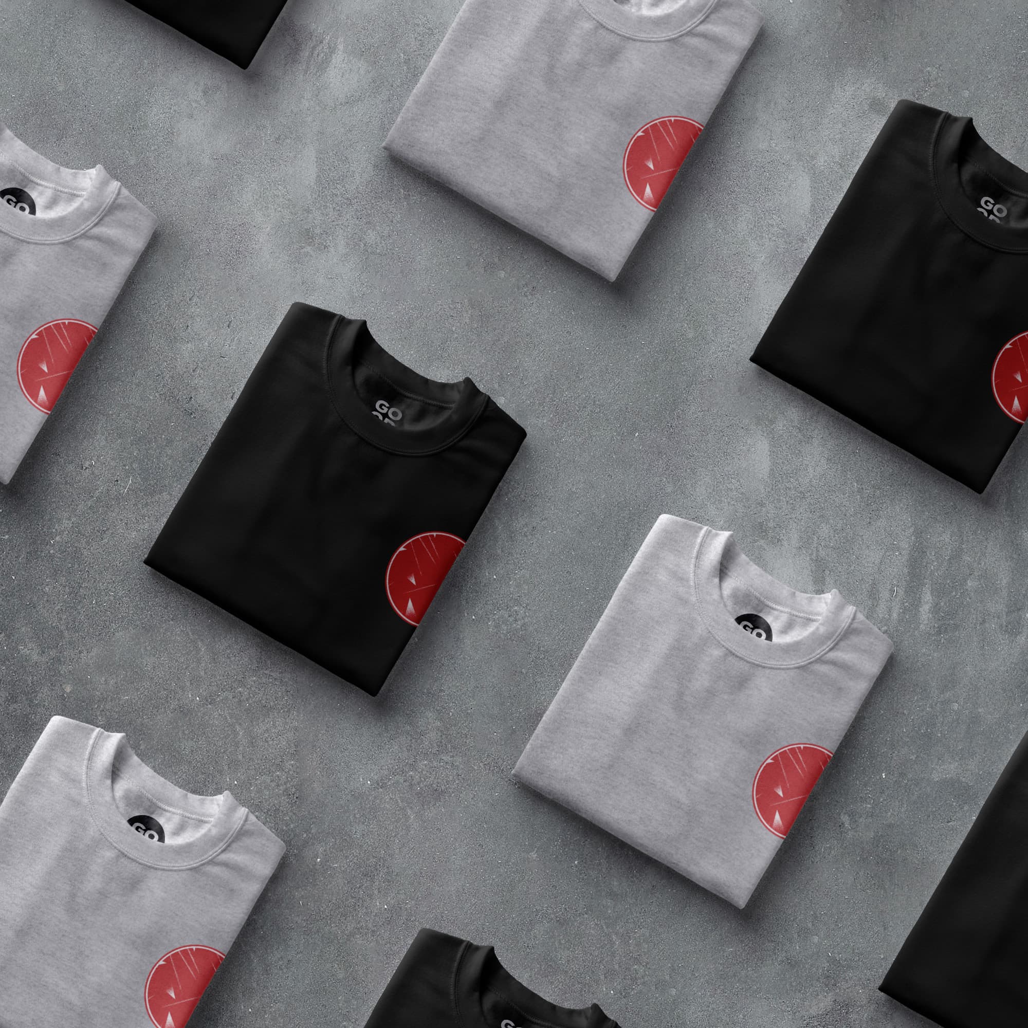 a group of black and white t - shirts with red circles on them