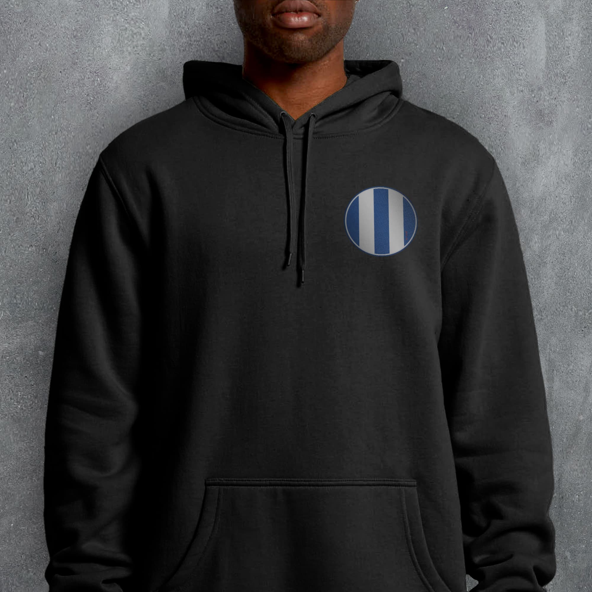 a man wearing a black hoodie with a blue and white stripe on it