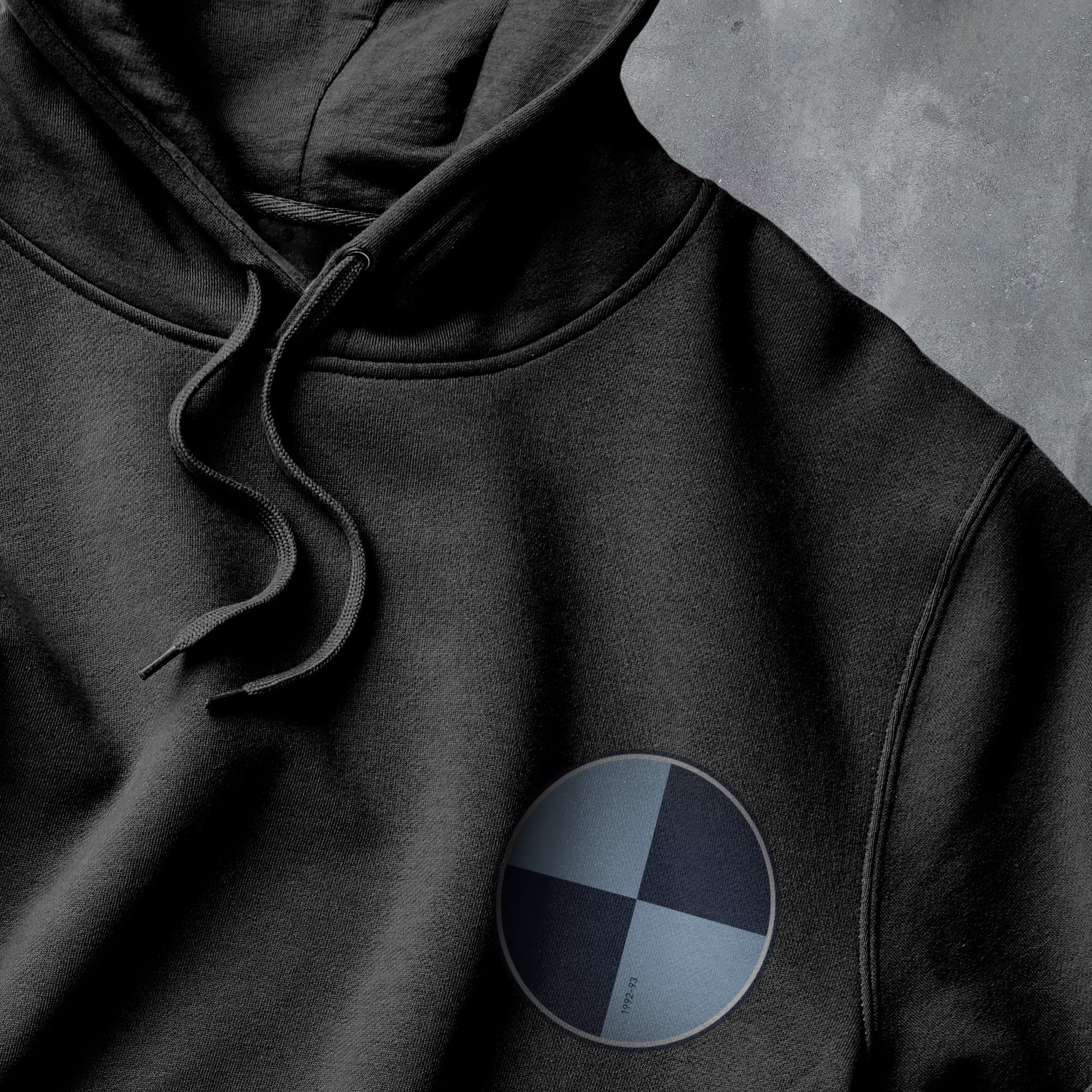 a close up of a black hoodie with a bmw emblem
