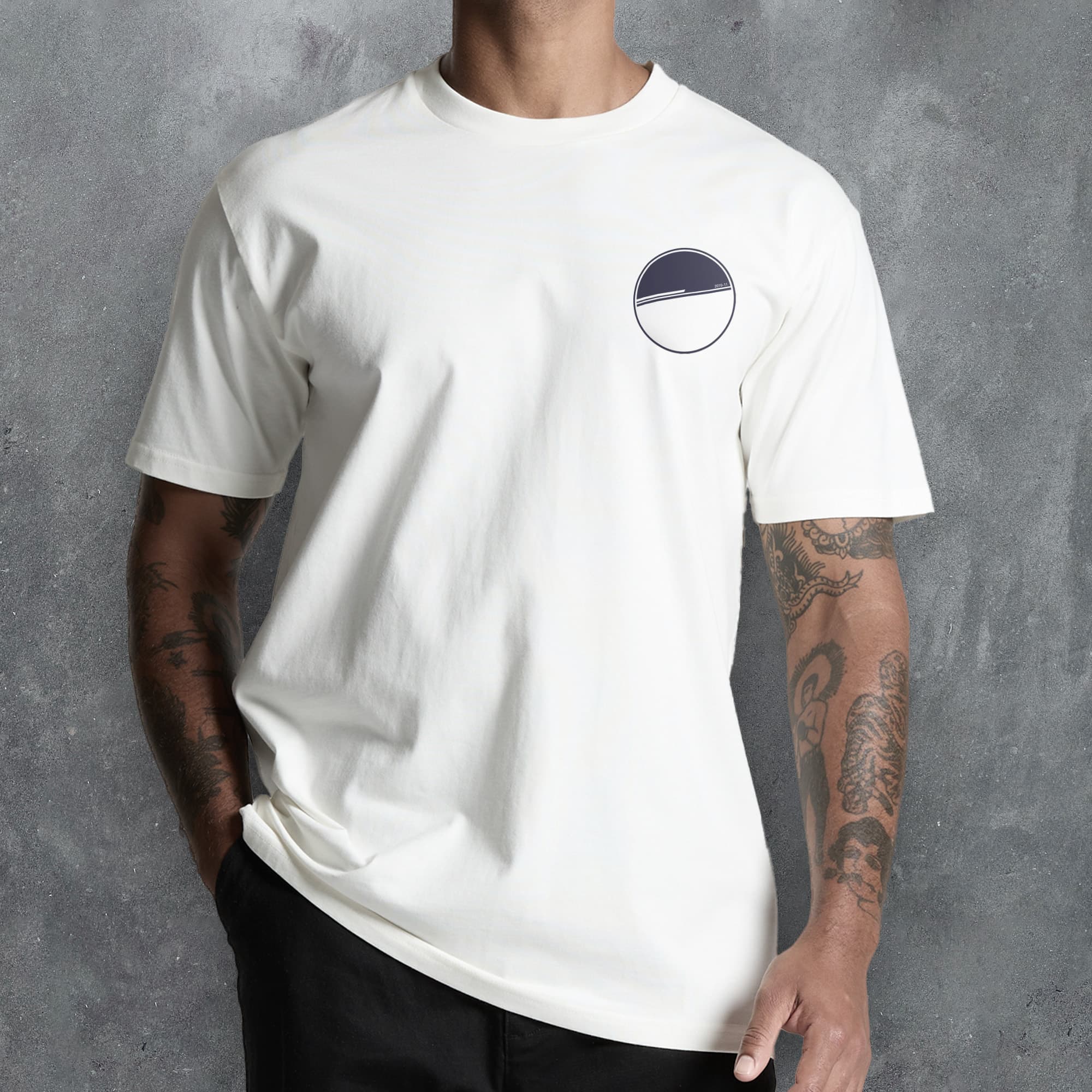 a man wearing a white t - shirt with a black circle on it