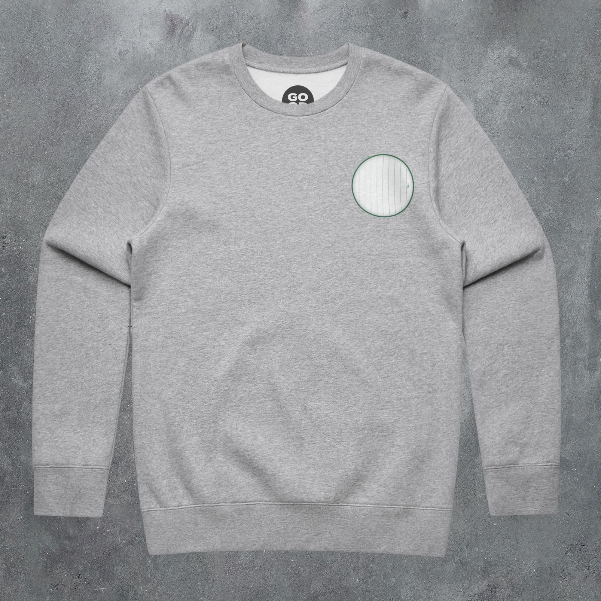 a grey sweatshirt with a green circle on the front