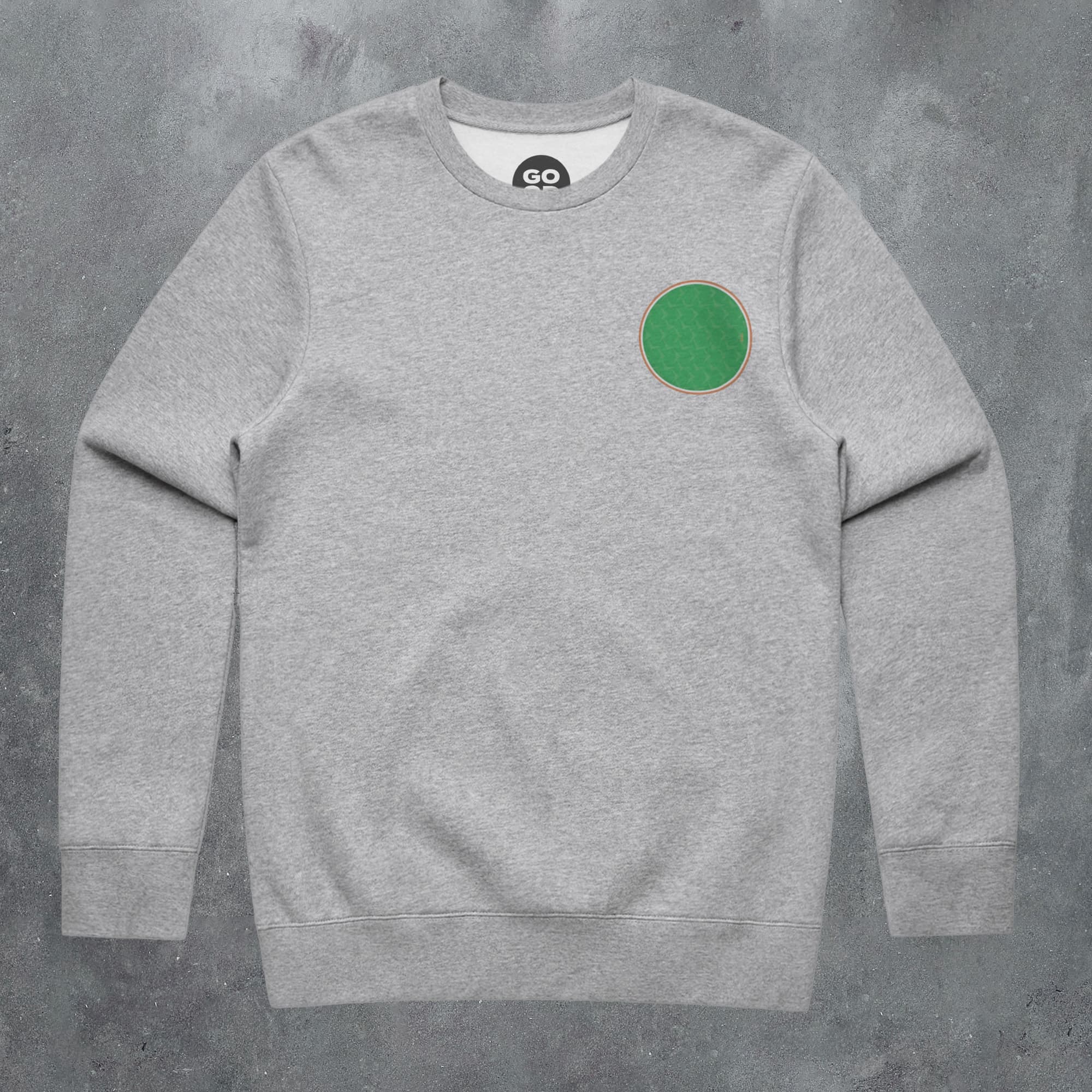 a grey sweatshirt with a green circle on the front