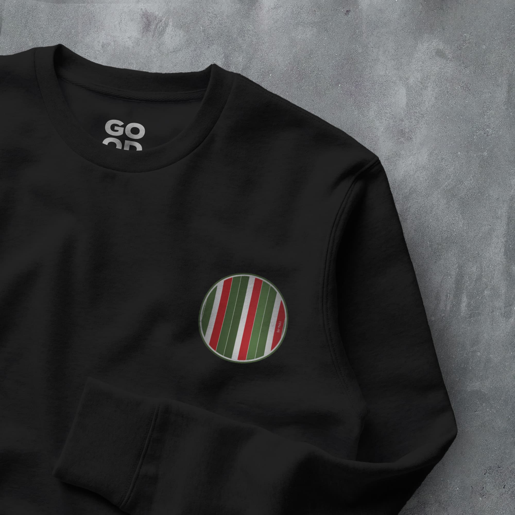 a black sweatshirt with a green and red striped pocket