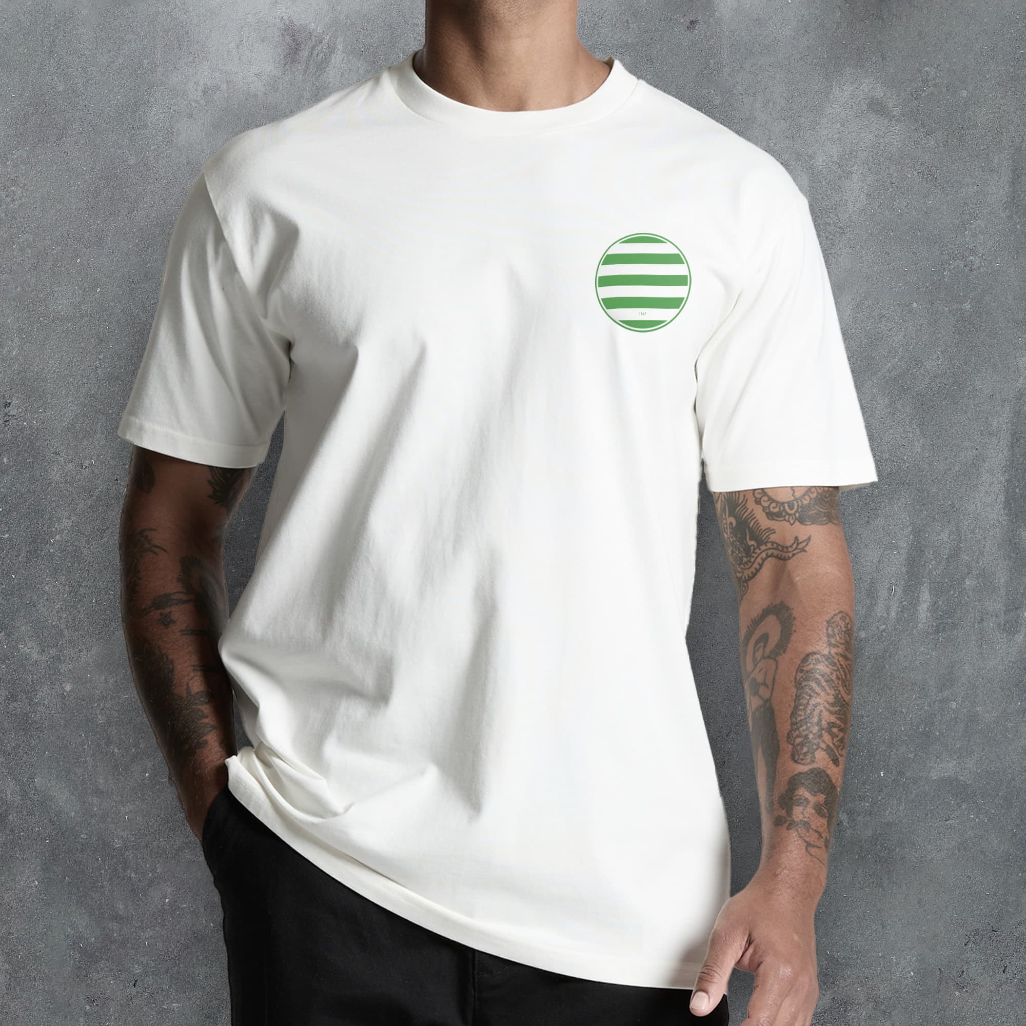 a man wearing a white t - shirt with a green circle on it