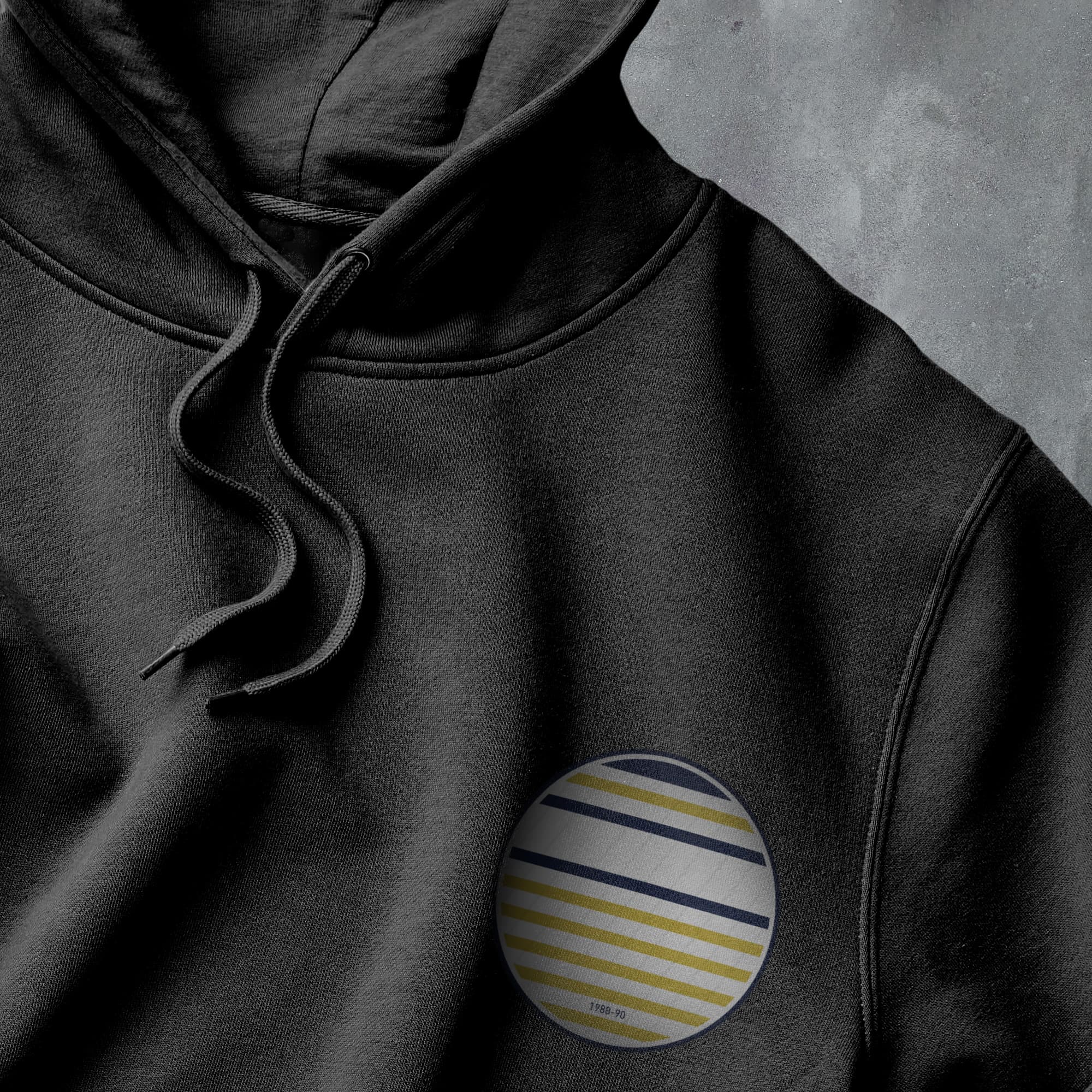 a close up of a black hoodie with a striped pocket