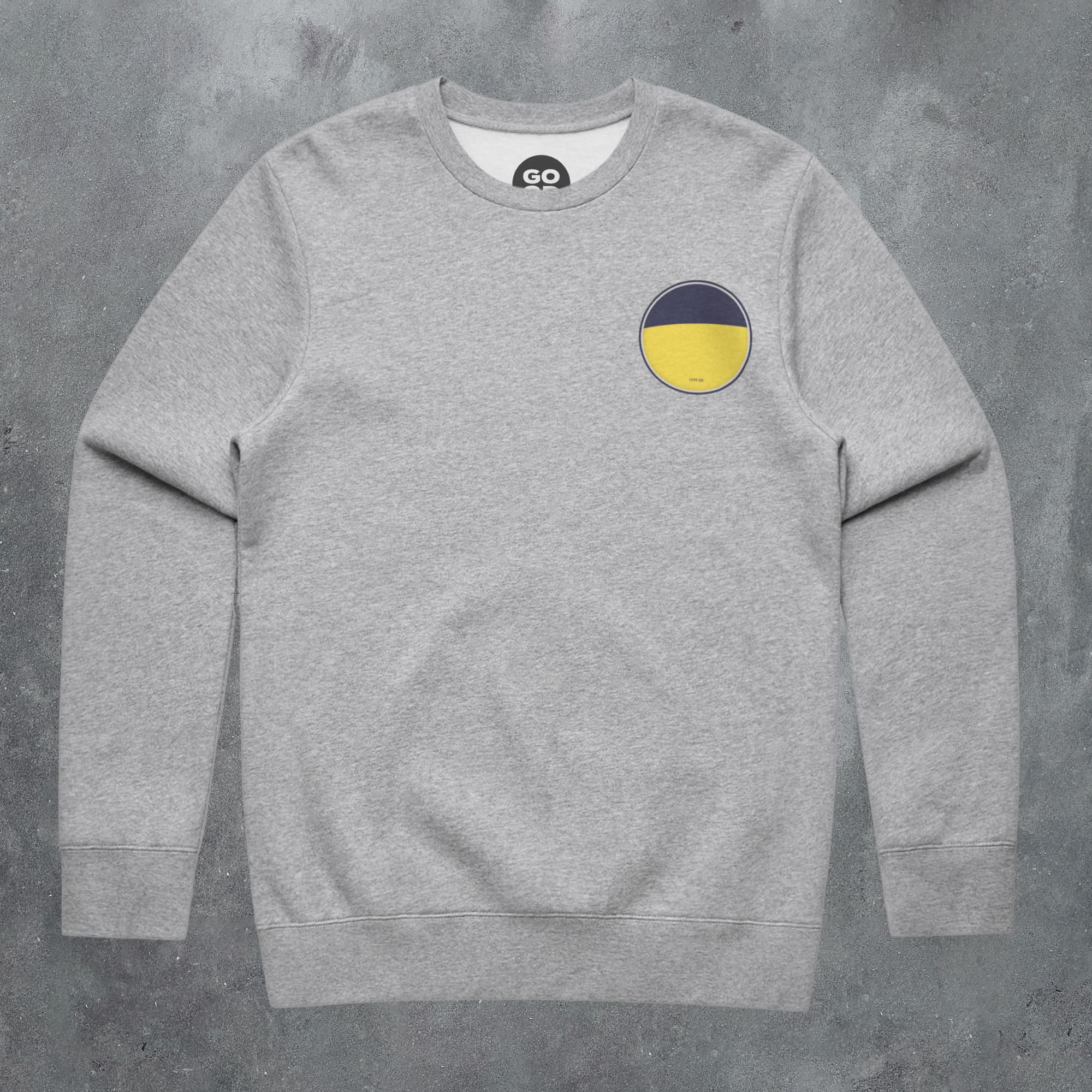 a grey sweatshirt with a yellow circle on the chest